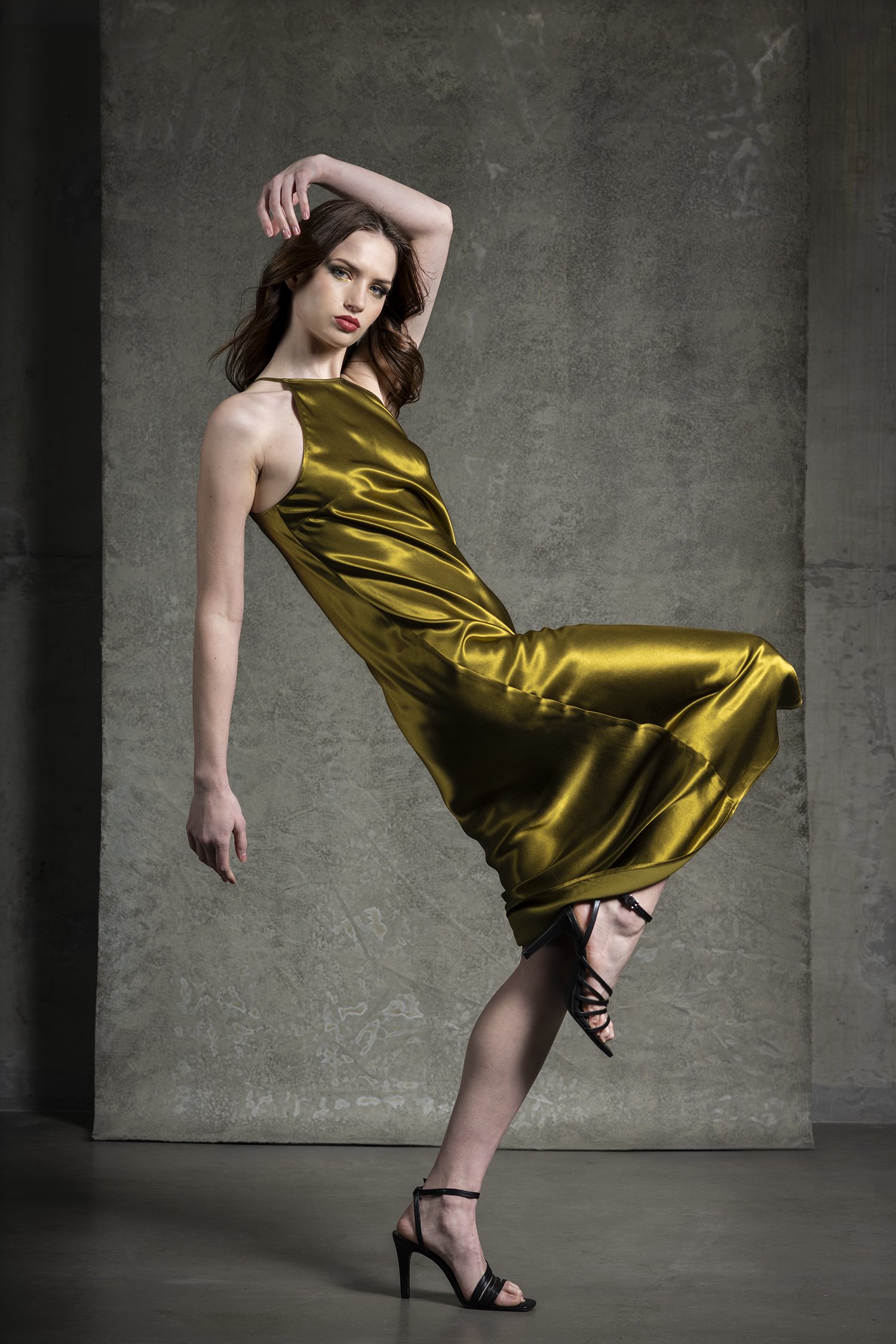 Photograph of woman in Rails green yellow silk evening gown with ladder photographed in Seattle High School Senior portraits