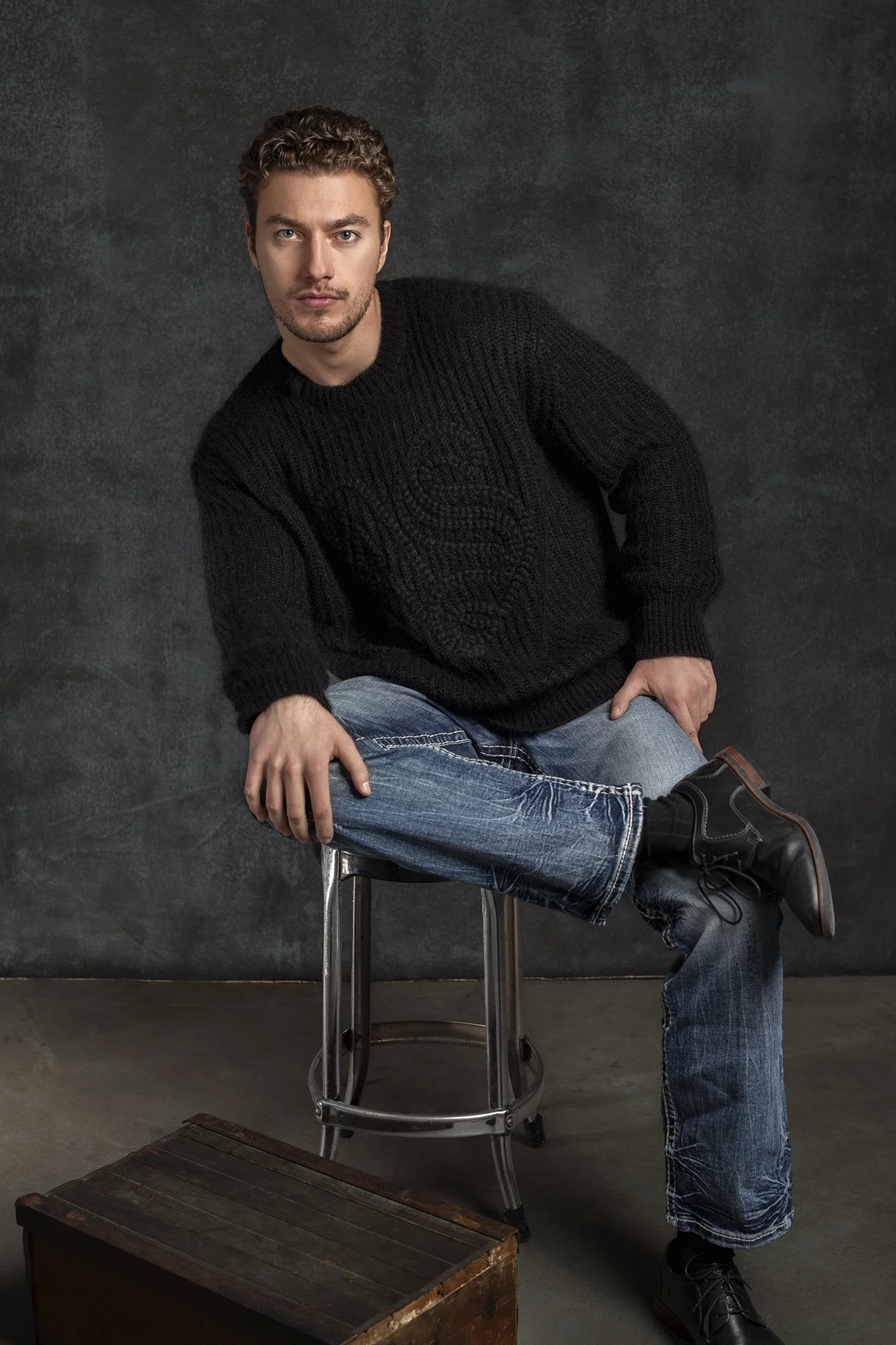 Male model in All Saints sweater photographed in Seattle in studio against hand painted backdrop  Los Angeles New York Profoto lighting gear