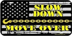 Black and white American flag background with yellow text that says 'Slow Down Move Over' and a yellow chain design.