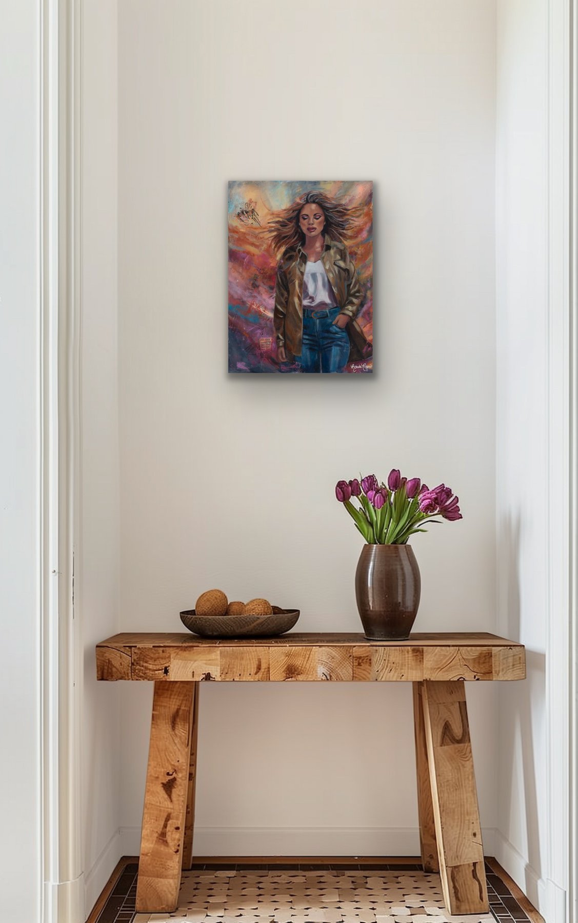 Embrace the Storm painting above a rustic wood console table with a bowl of wooden spheres and a vase of purple tulips