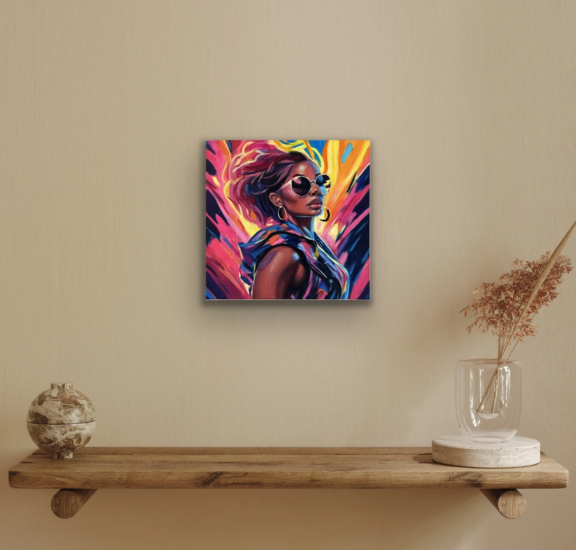 A colorful portrait of a woman in sunglasses and hoop earrings hanging above a wooden shelf with décor objects.