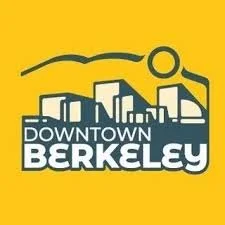 Logo for Downtown Berkeley with a stylized city skyline and a sun or circle in the background on a yellow background.