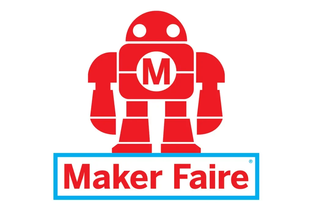 Red robot with the letter M on its chest and the words Maker Faire in red and blue below it.