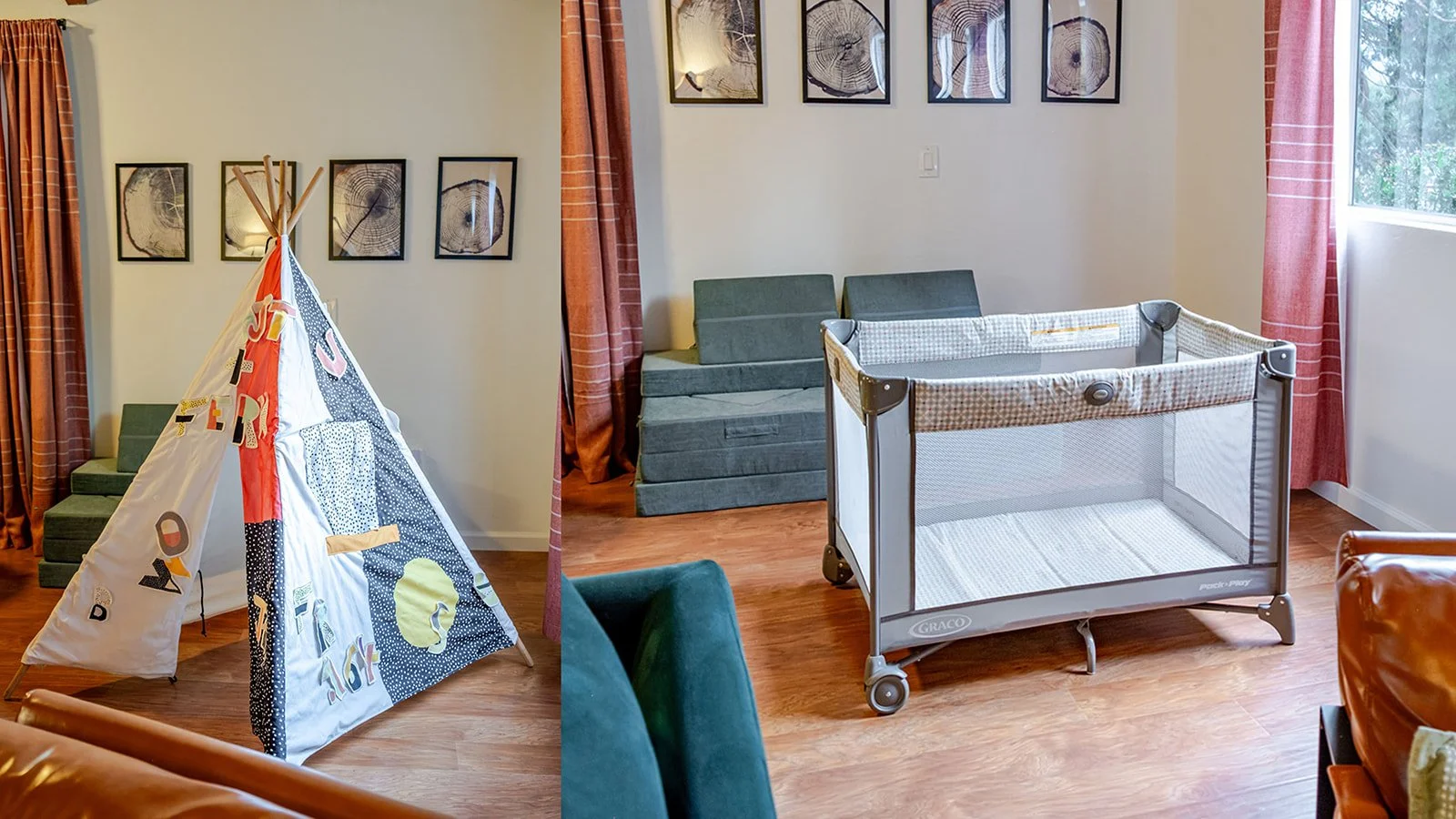 Living room with a play tent, a fold-out couch, a baby crib, framed tree ring artwork on the wall, and windows with pink curtains.