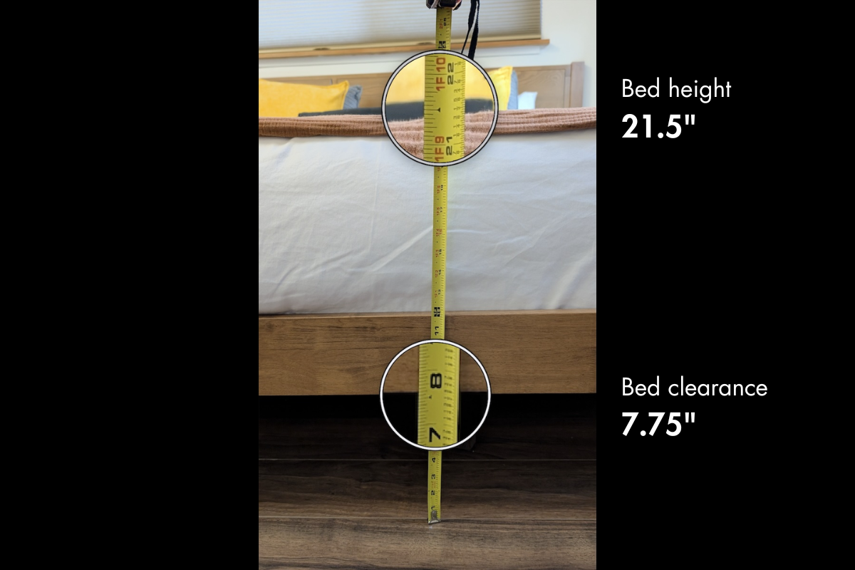 Measuring tape showing bed height of 21.5 inches and bed clearance of 7.75 inches in a bedroom with a bed, pillows, and wooden floor.