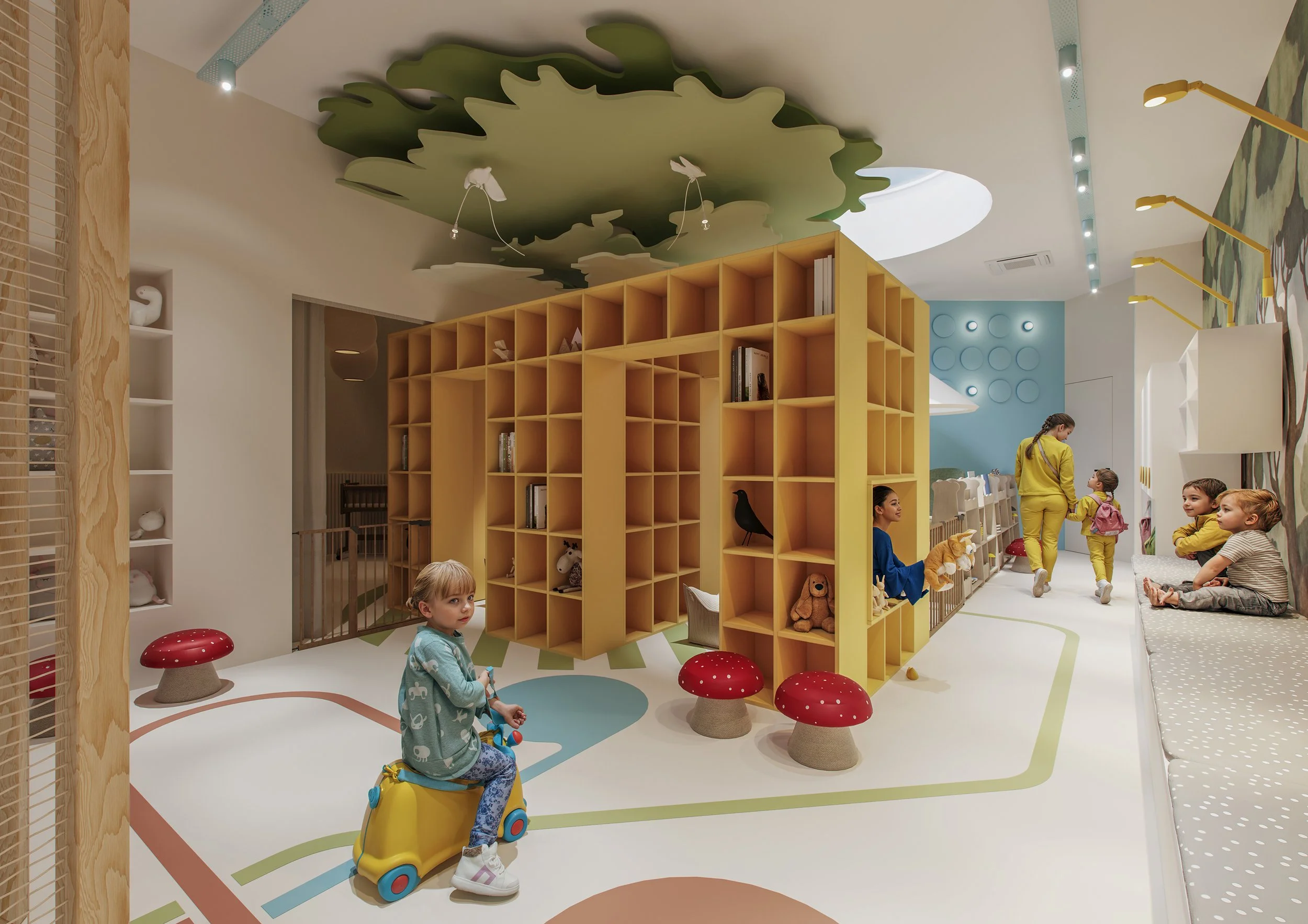 Children playing in a colorful indoor play area with a yellow bookshelf, mushroom-shaped seats, and wall art.