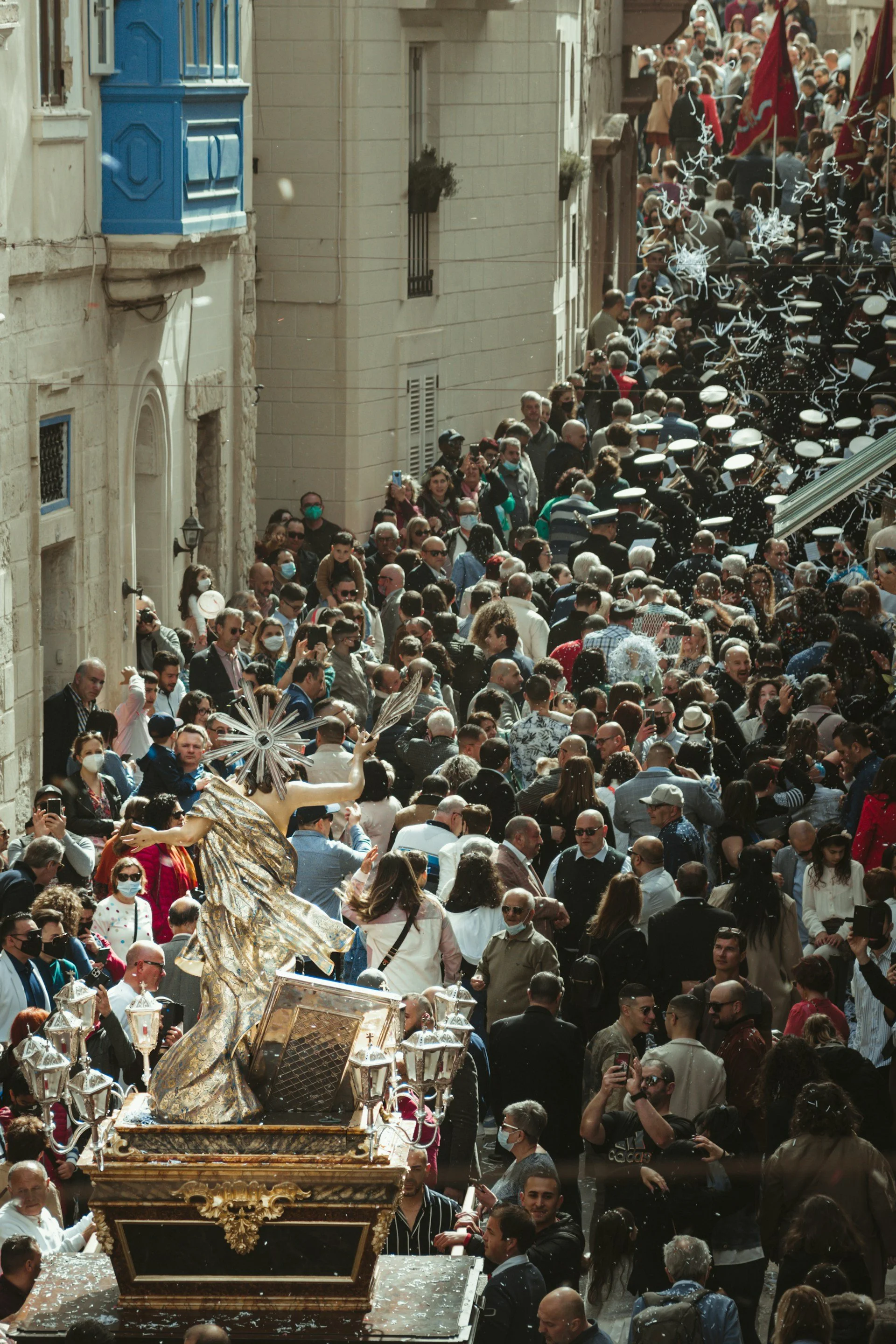 Easter procession in Malta moving through a narrow limestone street, illustrating spatial compression, sequence and activation of urban architecture