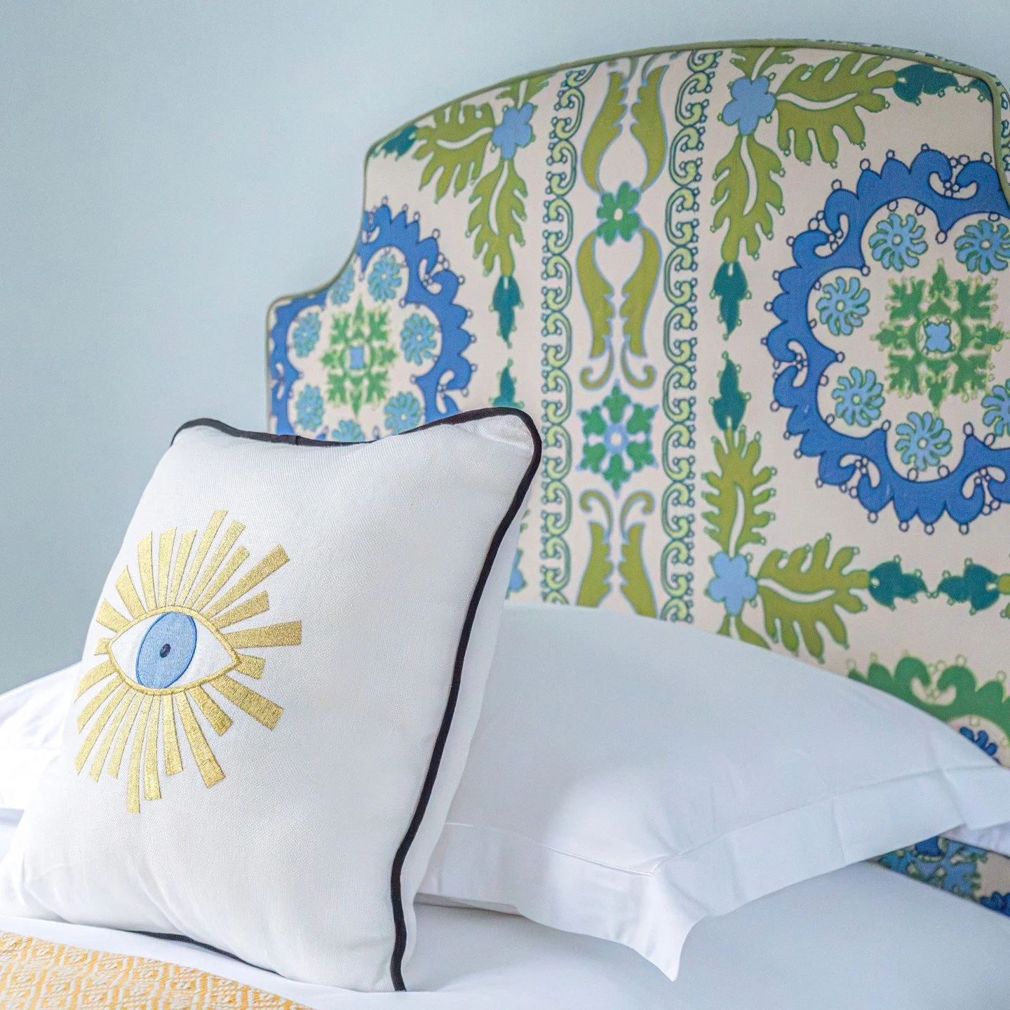 A twin room sitting at the top of the house deserved something uplifting rather than forgotten. We created a pair of bespoke headboards in a Manuel Canovas Suzani style weave, full of vivid colour in violet blue and lime green. They bring personality