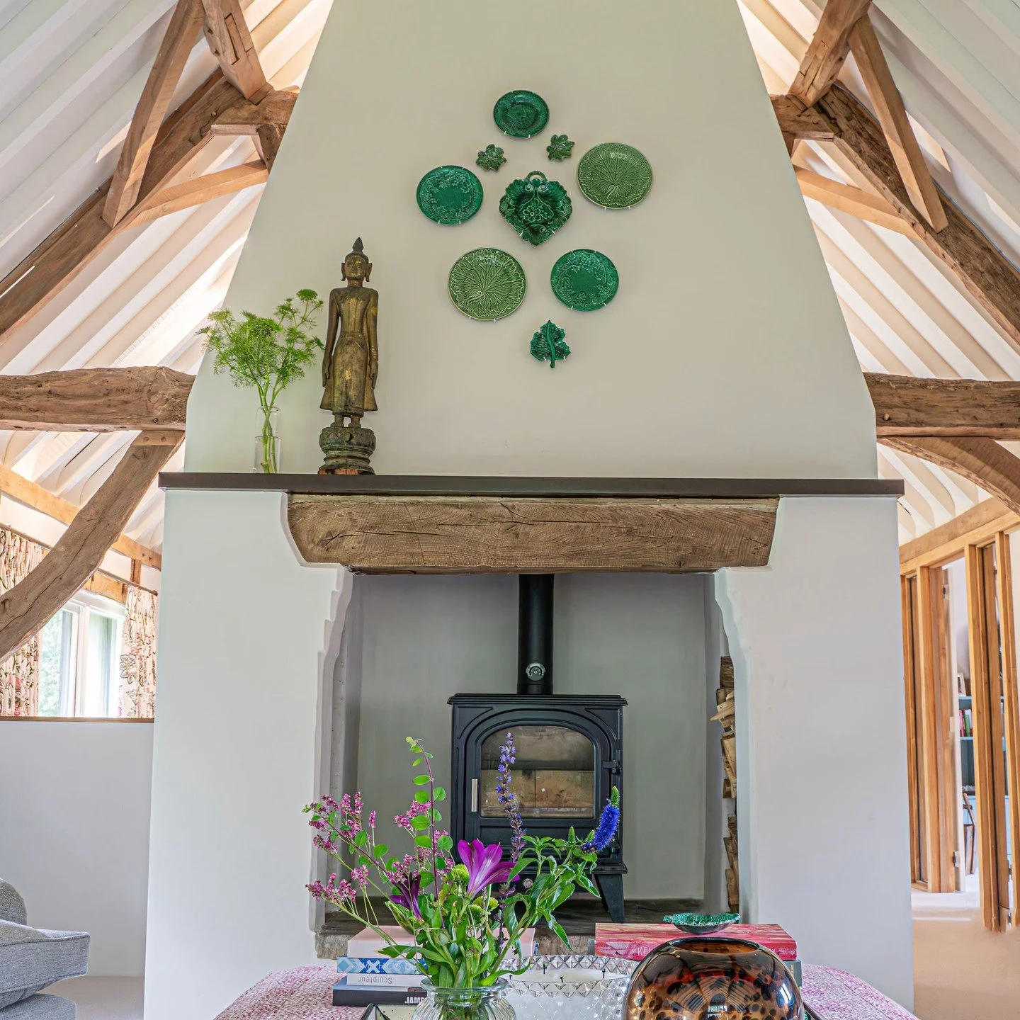 This fireplace is very much part of the architecture.

In a barn like this, the A frame is everything. We kept the original structure exposed, but painted out the false beams so the timber above did not feel heavy or overpowering. It needed breathing