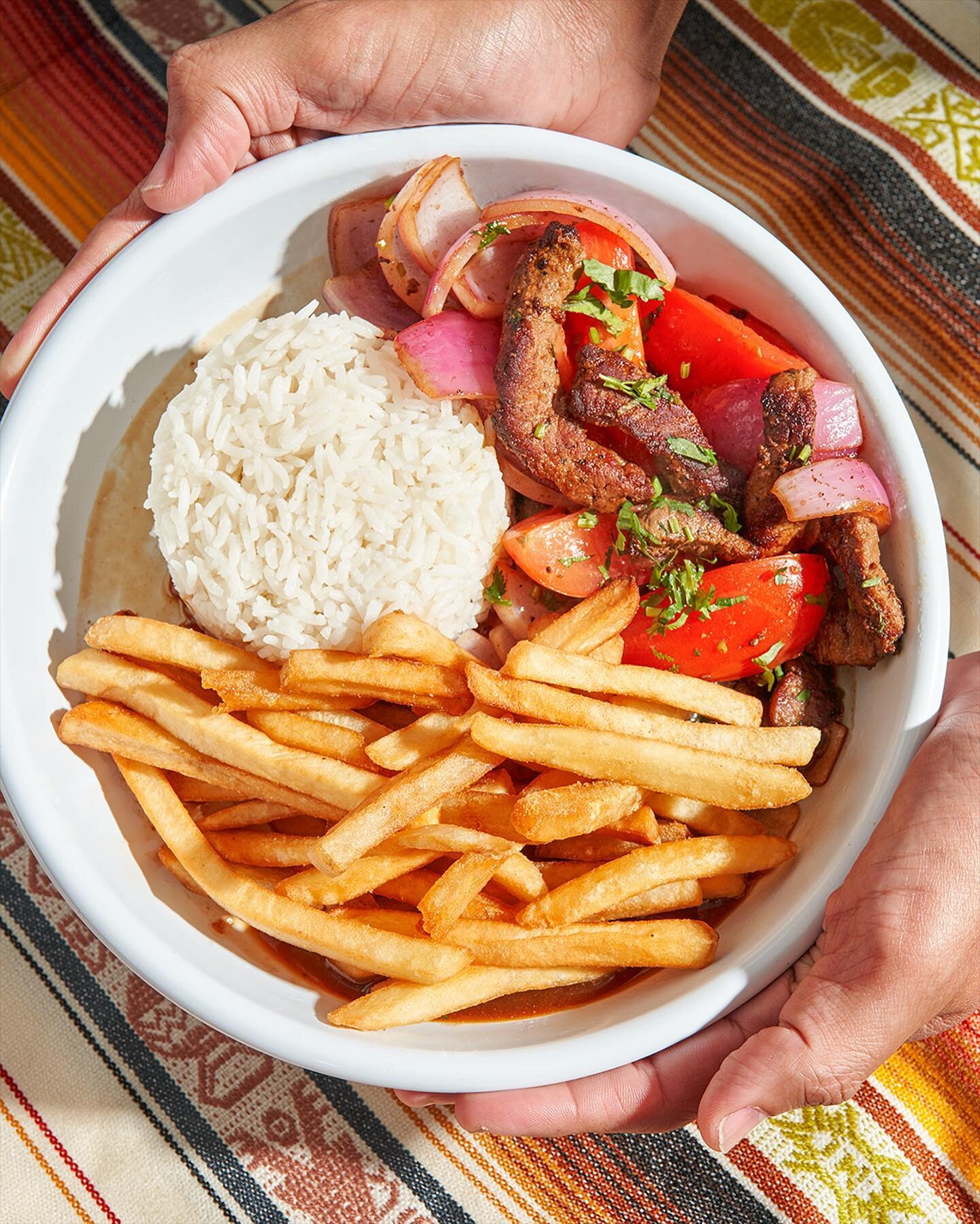 Lomo saltado! 🇵🇪 
Tender strips of steak stir-fried with onions, tomatoes, and French fries + rice!

The dish originated as part of the chifa tradition, the Chinese cuisine of Peru, though its popularity has made it part of the mainstream culture. 