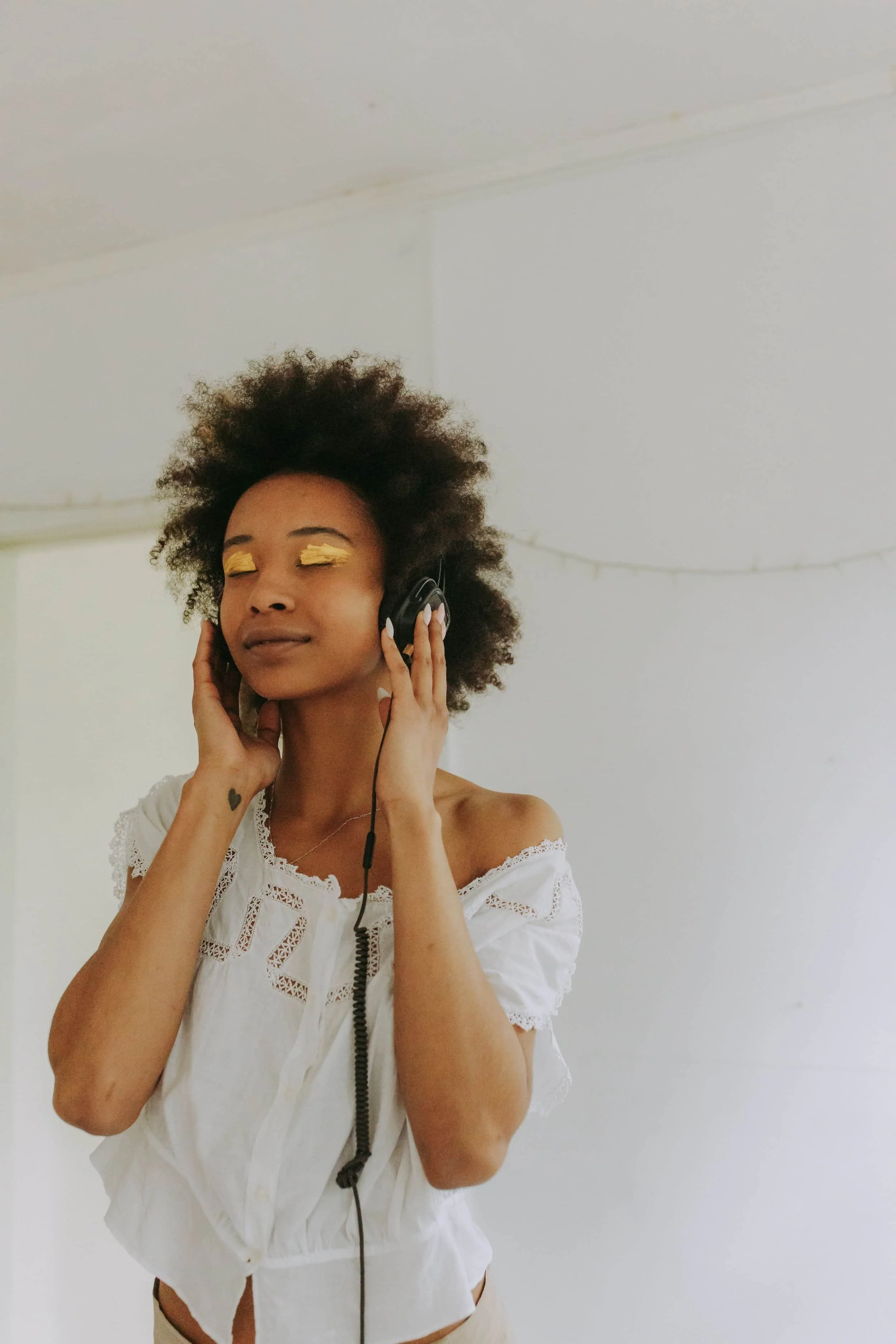 Person of color wearing headphones with relaxed expression in Maryland