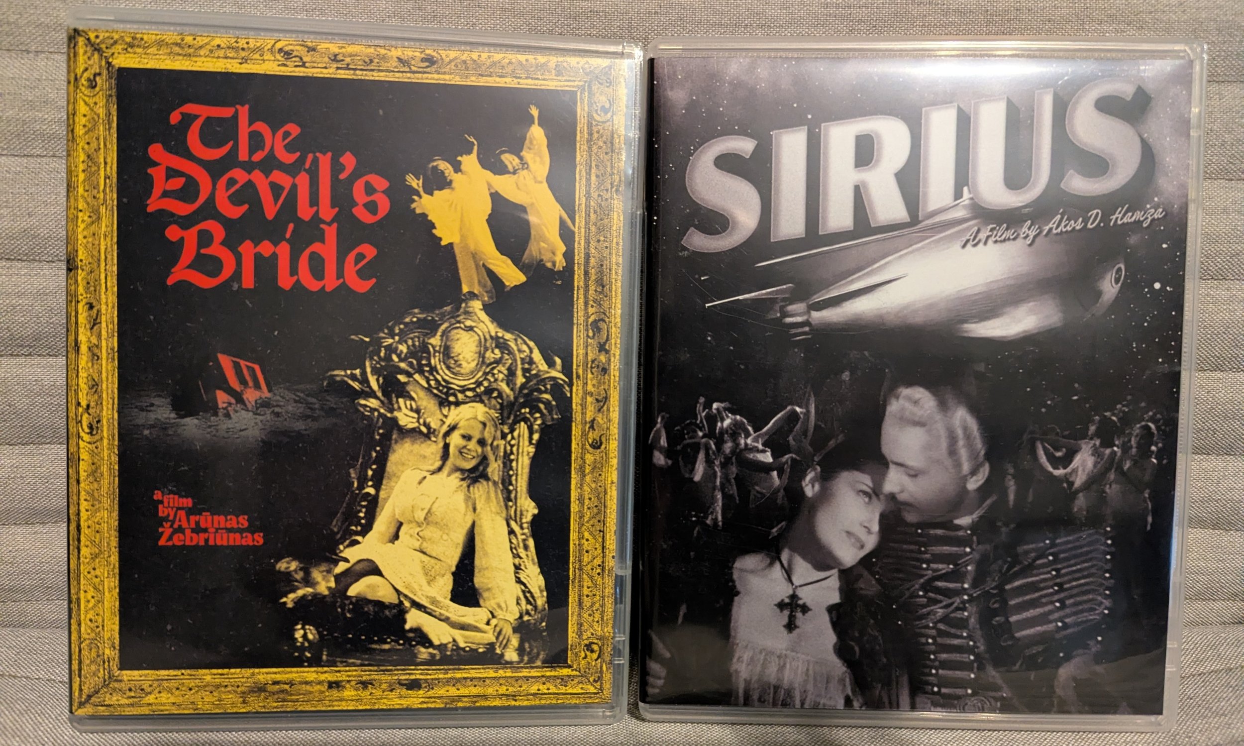 Two movie cases. On left is "The Devil's Bride." Collage of a woman in a throne and two people dancing, both in sepia. On right is "Sirius." Black and white image of man and woman in embrace with other people overhead and a spaceship and movie title.