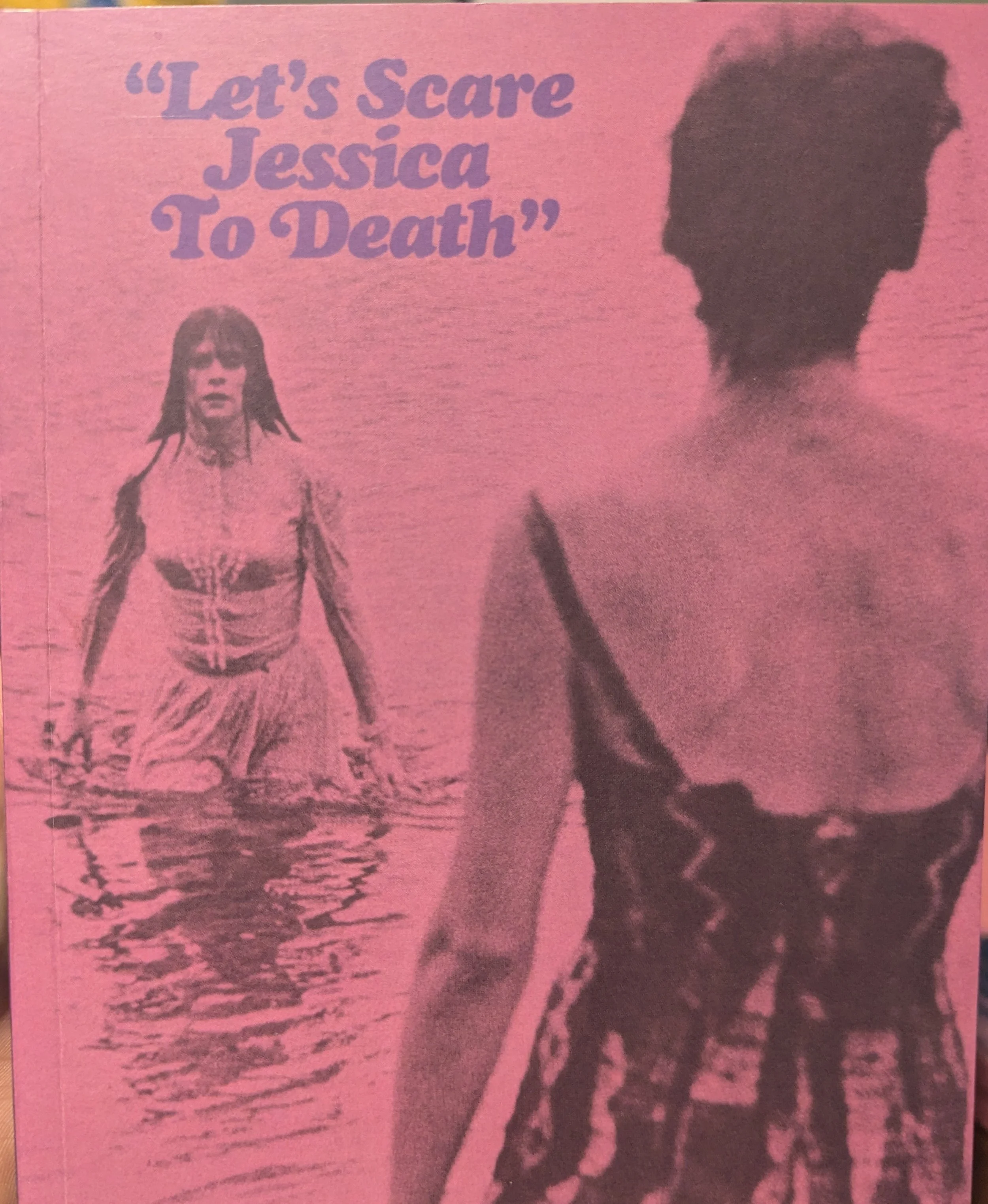 The cover of the booklet for "Let’s Scare Jessica to Death." A pink image, movie title in purple text. Two woman in a lake, one is facing away wearing a bathing suit, the other is approaching and wearing a full Victoria-era dress.