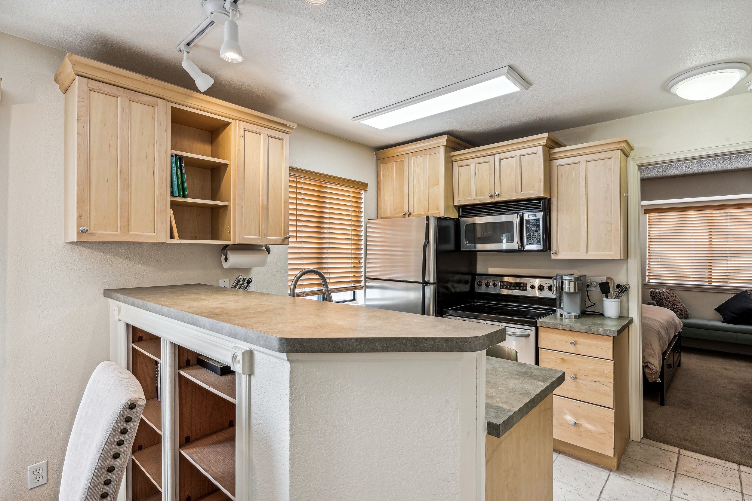 Unit 207 - A photograph of the kitchen. Ample counter space featured.