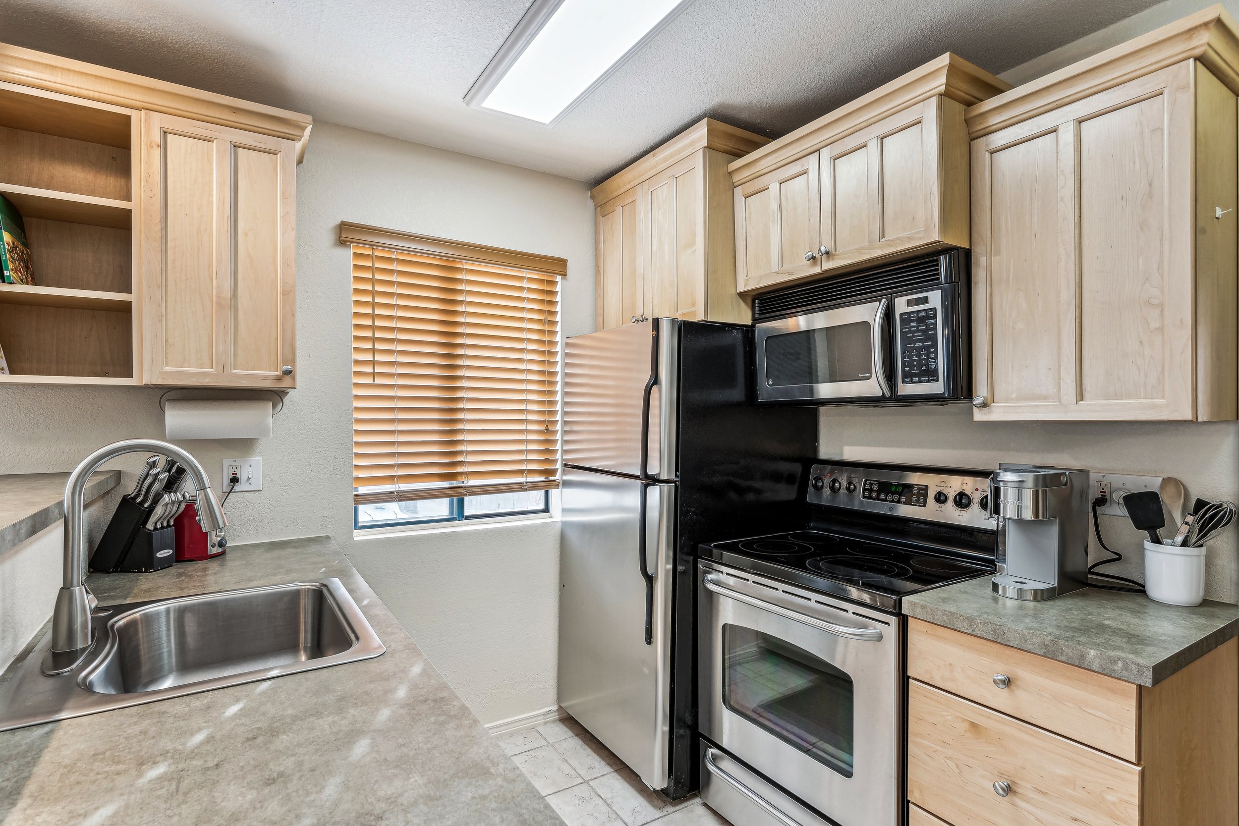 Unit 207 - A photograph of the kitchen. Stainless steel appliances featured.