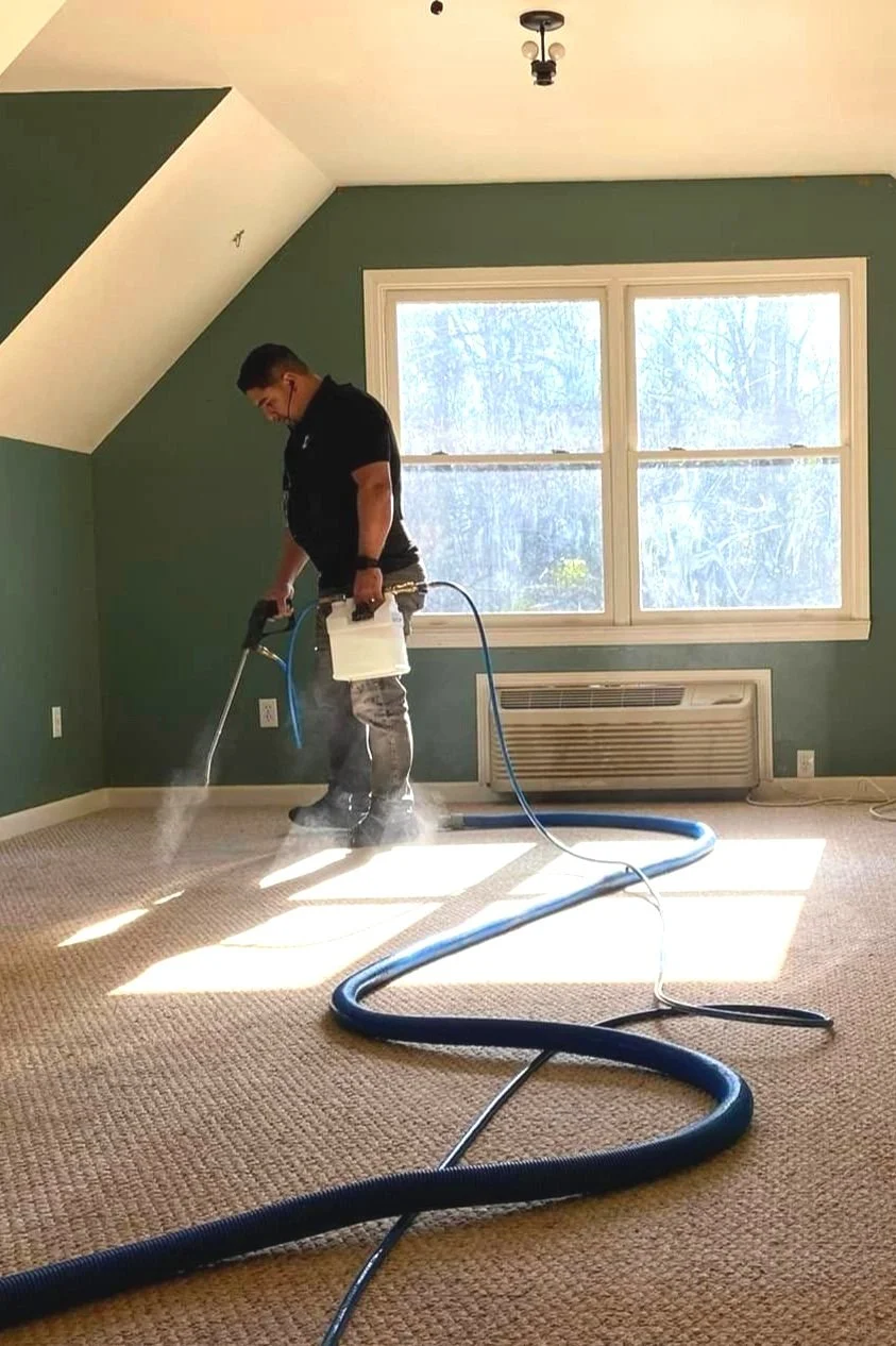 Technician performing residential carpet cleaning