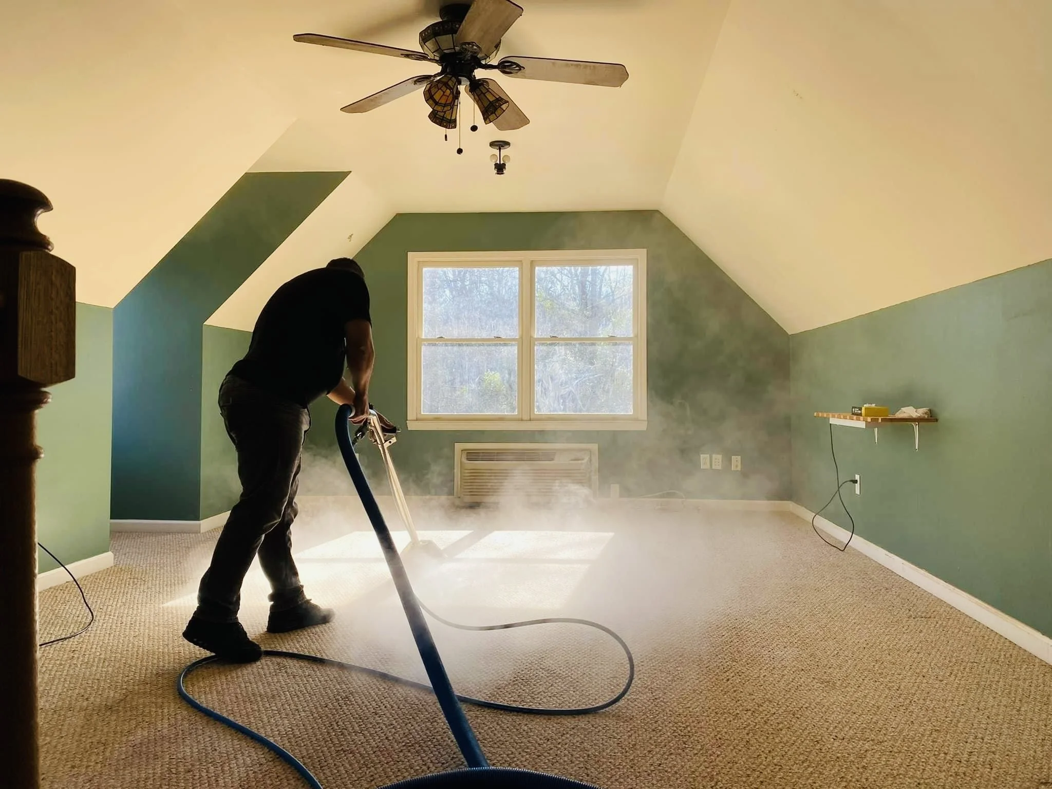 Technician performing residential carpet cleaning