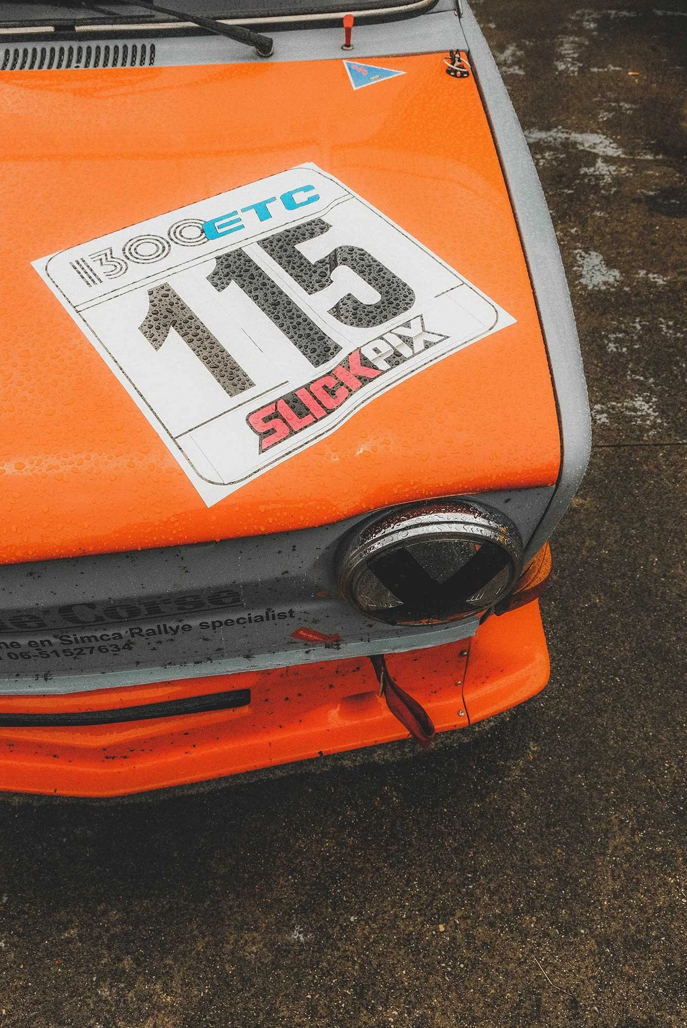 Front fender badge detail photo of a vintage 1966 blue NSU Prinz 1000 TT car in a mountain road location. Bespoke build by premium car restoration and modification workshop Retro Sporting in California.