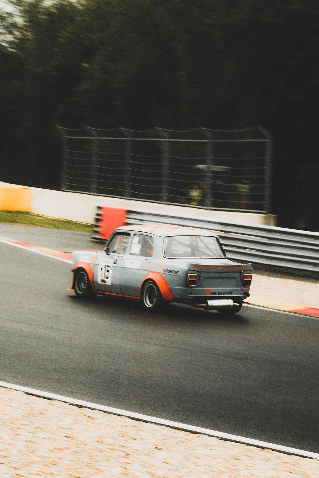 Front light detail photo of a vintage 1966 blue NSU Prinz 1000 TT car in a workshop location. Bespoke build by premium car restoration and modification workshop Retro Sporting in California.