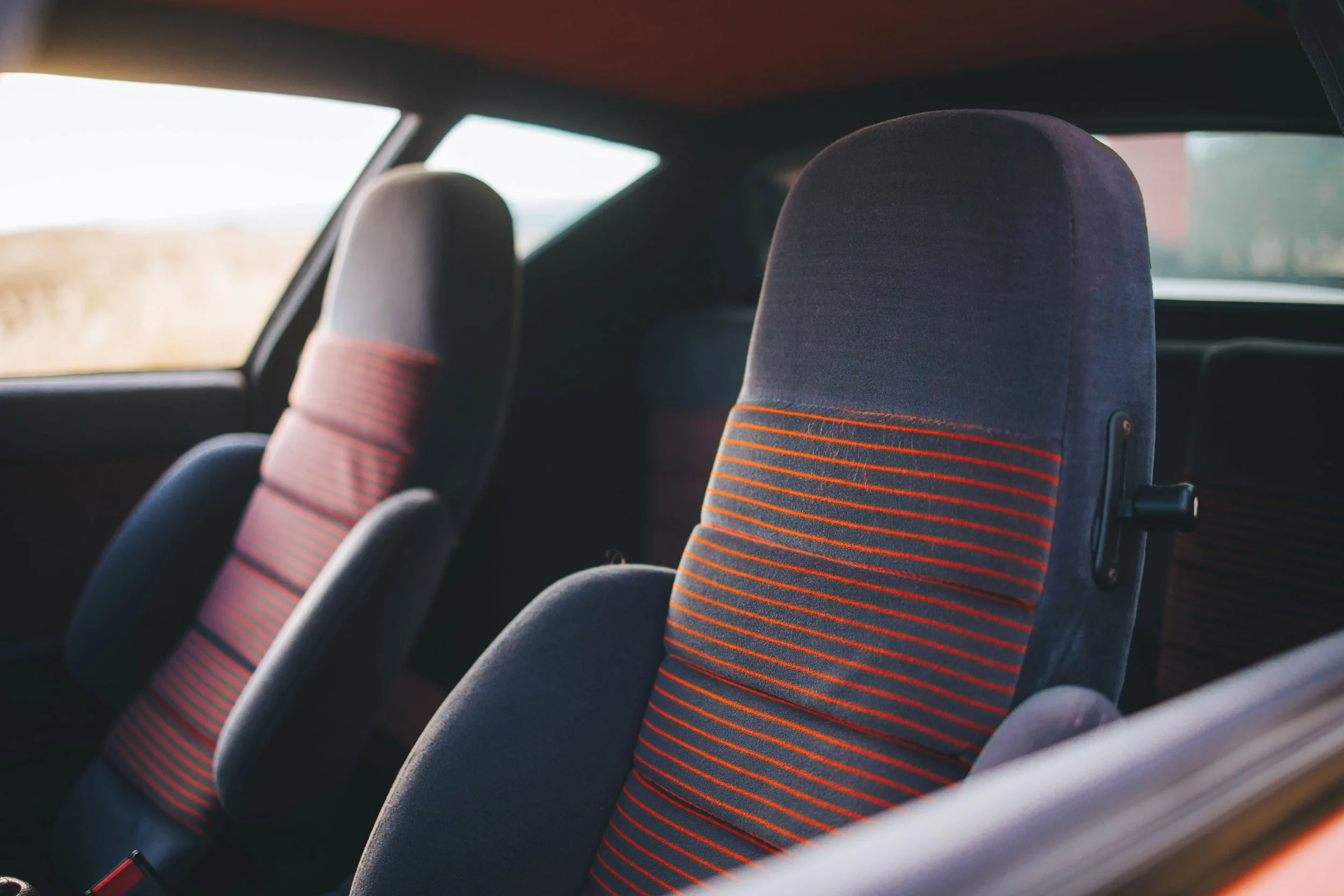 Interior seats view photo of a vintage 1980 red Alpine A310 car. Bespoke build by premium car restoration and modification workshop Retro Sporting in California.