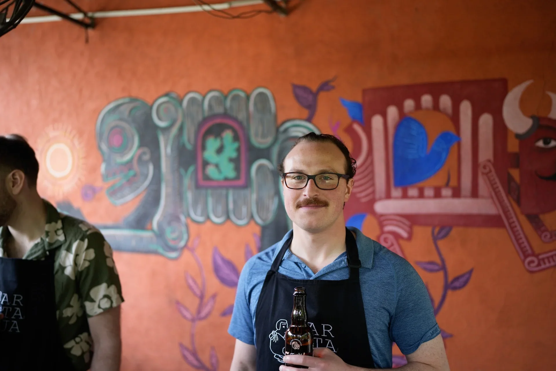 A guest enjoying a craft beer at a cooking class on the rooftop of a Condesa art gallery in Mexico City.