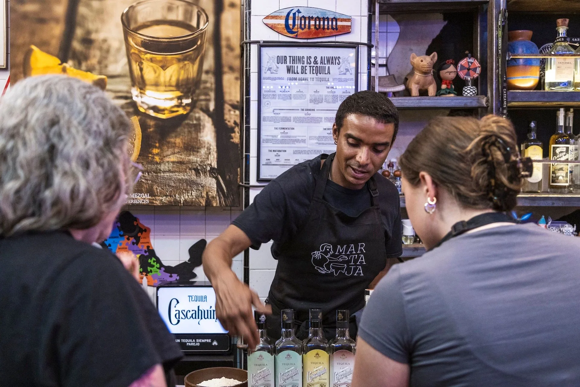 A Martaja chef explains the history of tequila, how it's made, and why it's different to mezcal at a tequila tasting given as part of a cooking class in an off-the-beaten-track location in Mexico City.