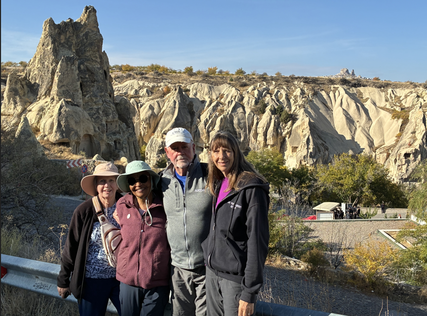 St Lukes cohort of pilgrims pose in front of an ancient rock formations in Turkey