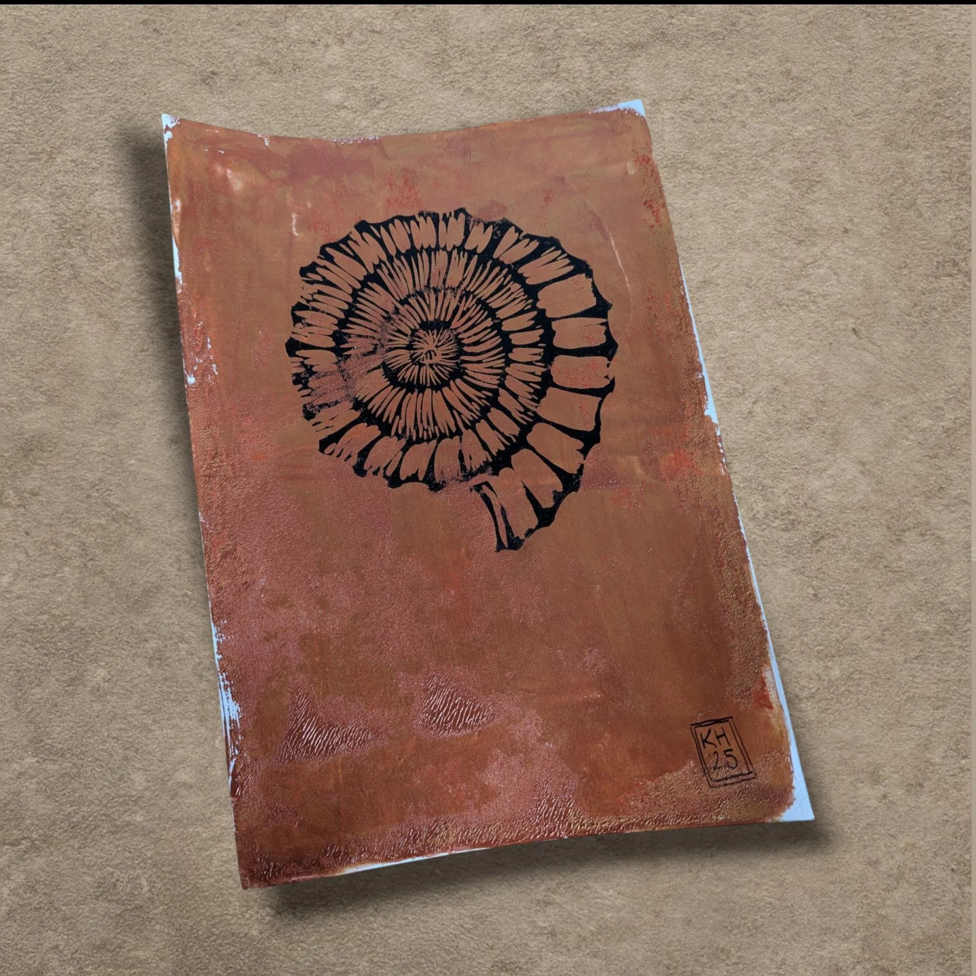 Ammonite: Earthen Sun - hand-printed lino print on monoprinted background