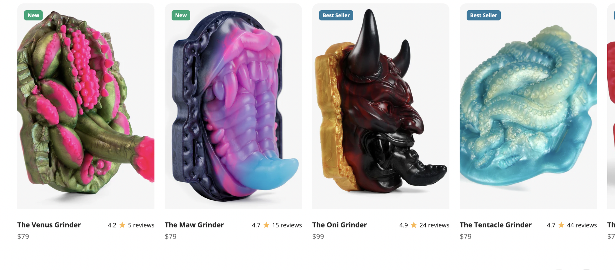 Collection of four colorful, artistic squishy toys shaped like grotesque faces or heads with exaggerated features, each labeled with product names and prices: The Venus Grinder, The Maw Grinder, The Oni Grinder, and The Tentacle Grinder.