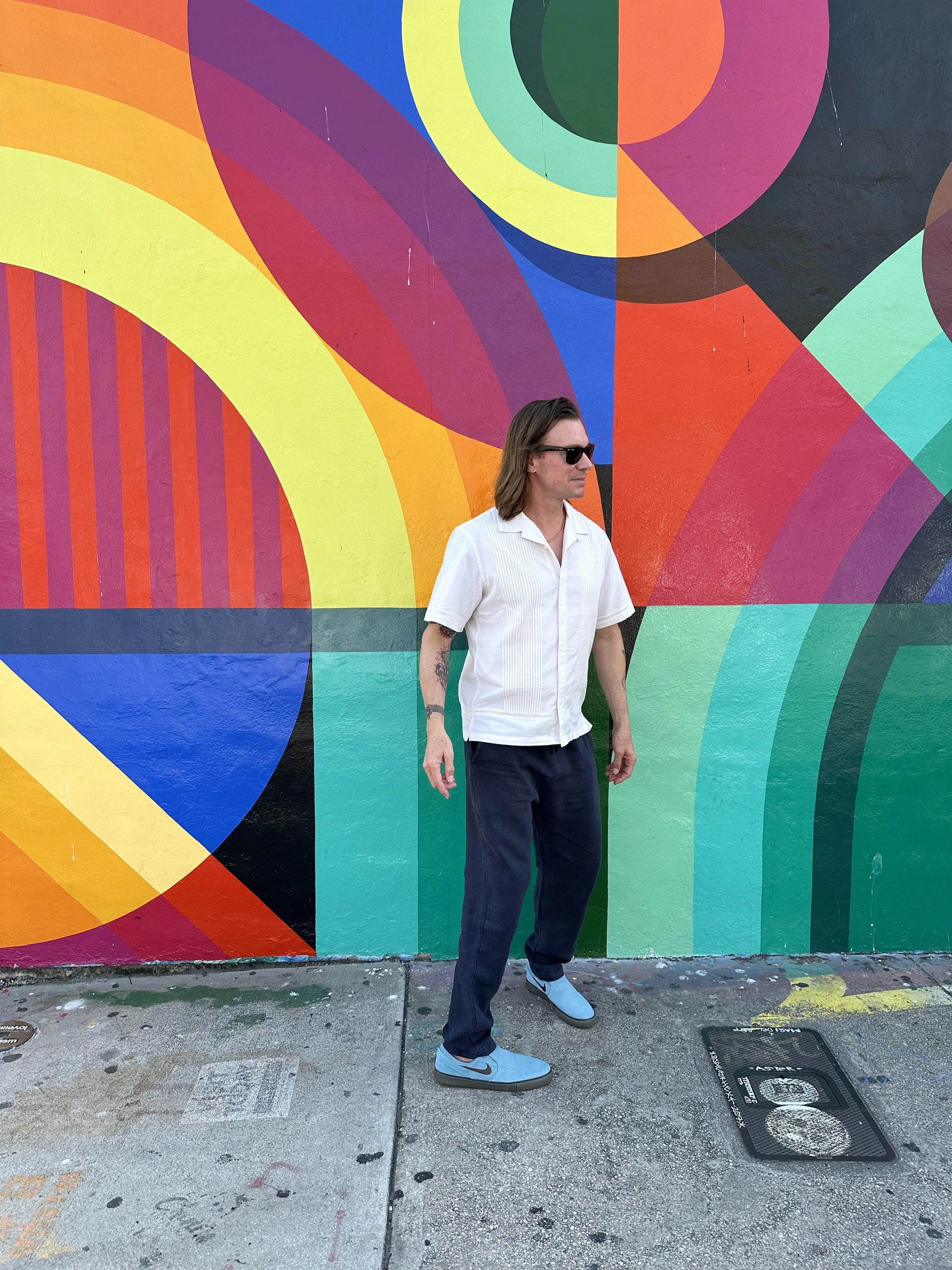 Person wearing Doc Flossin's Hemp Chinos standing in front of a vibrant mural