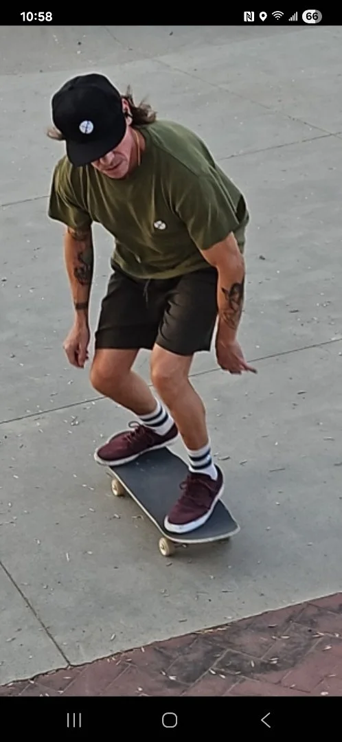 Doc Flossin's Feels Hemp Dad Hat, Hemp tee shirt, and Hemp Socks worn by a man riding a skateboard 