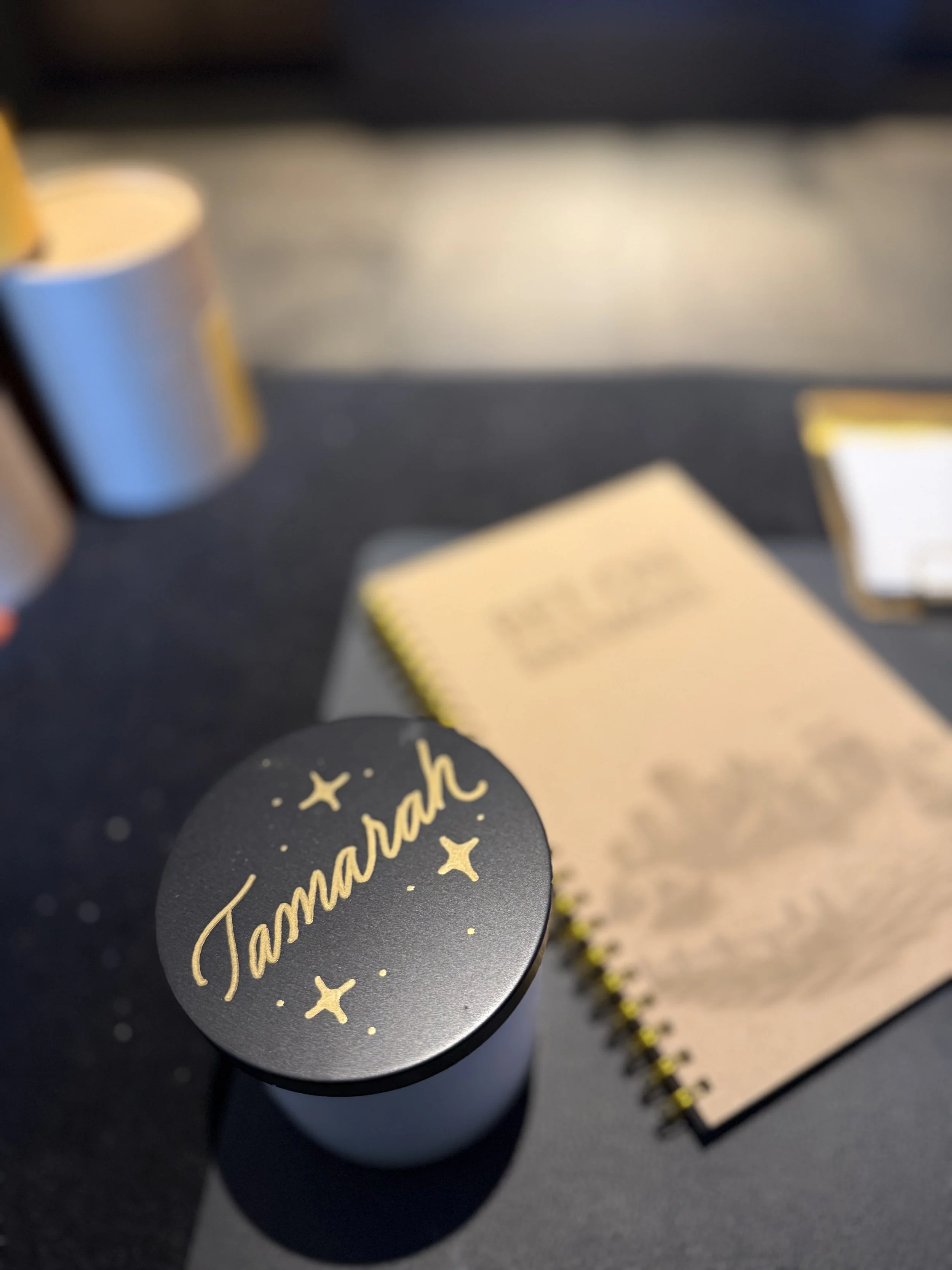 Big Bets for America Conference | One of two artists personalizing candles and notebooks for speakers and attendees, creating thoughtful keepsakes connected to the conference experience.