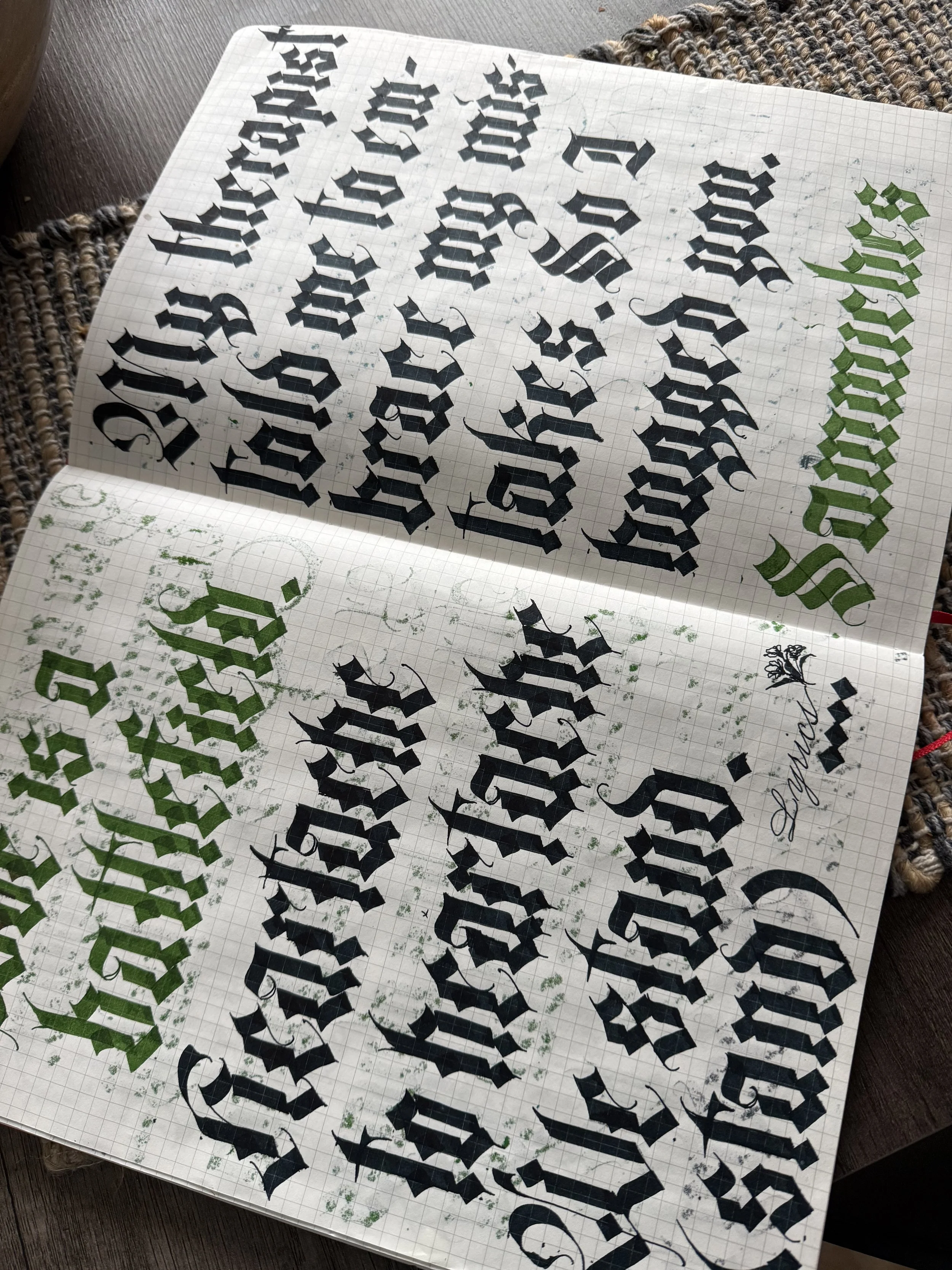 textura blackletter written in a gridded notebook spread