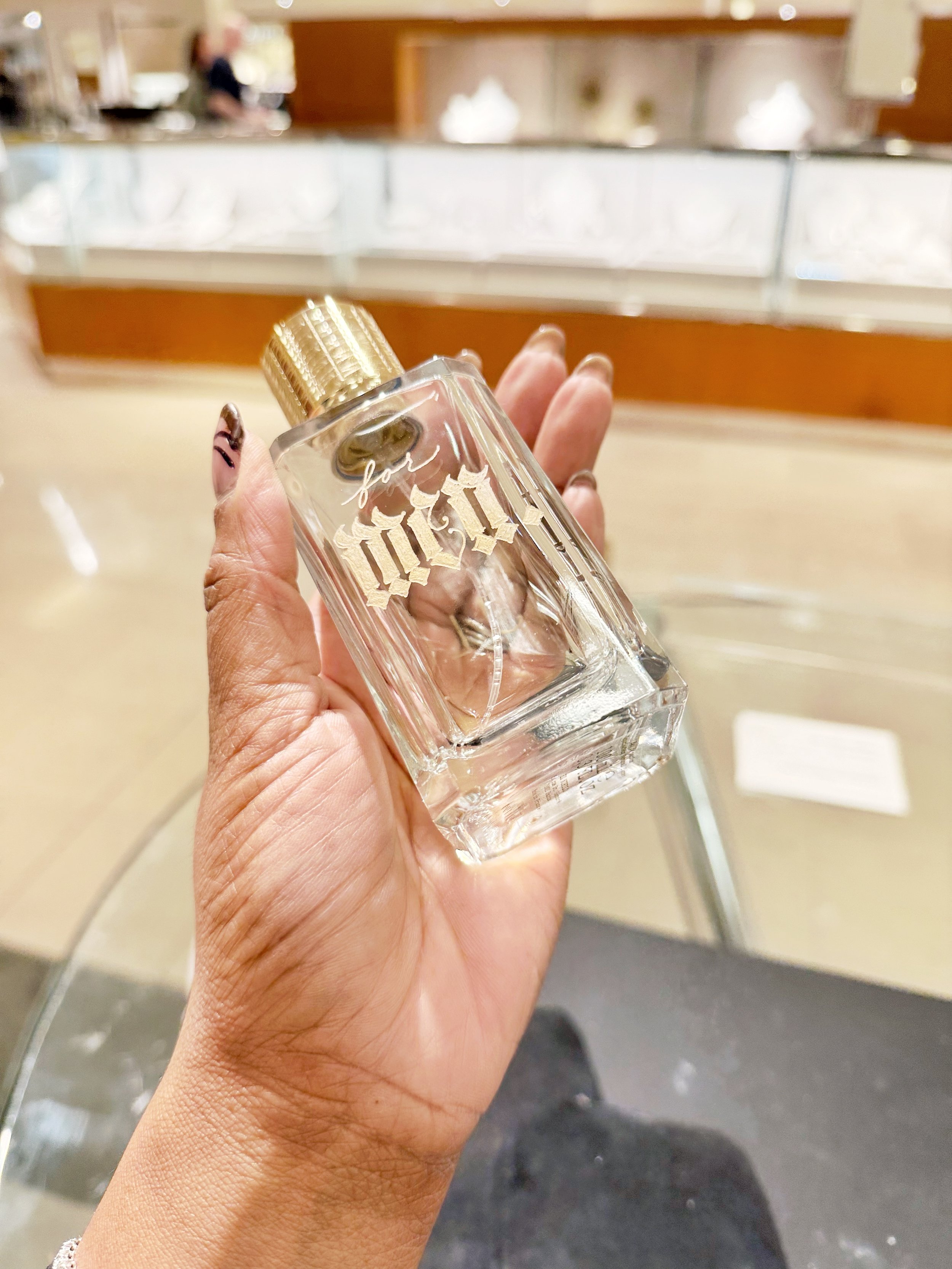 fragrance bottle with the word men engraved in blackletter on the bottle