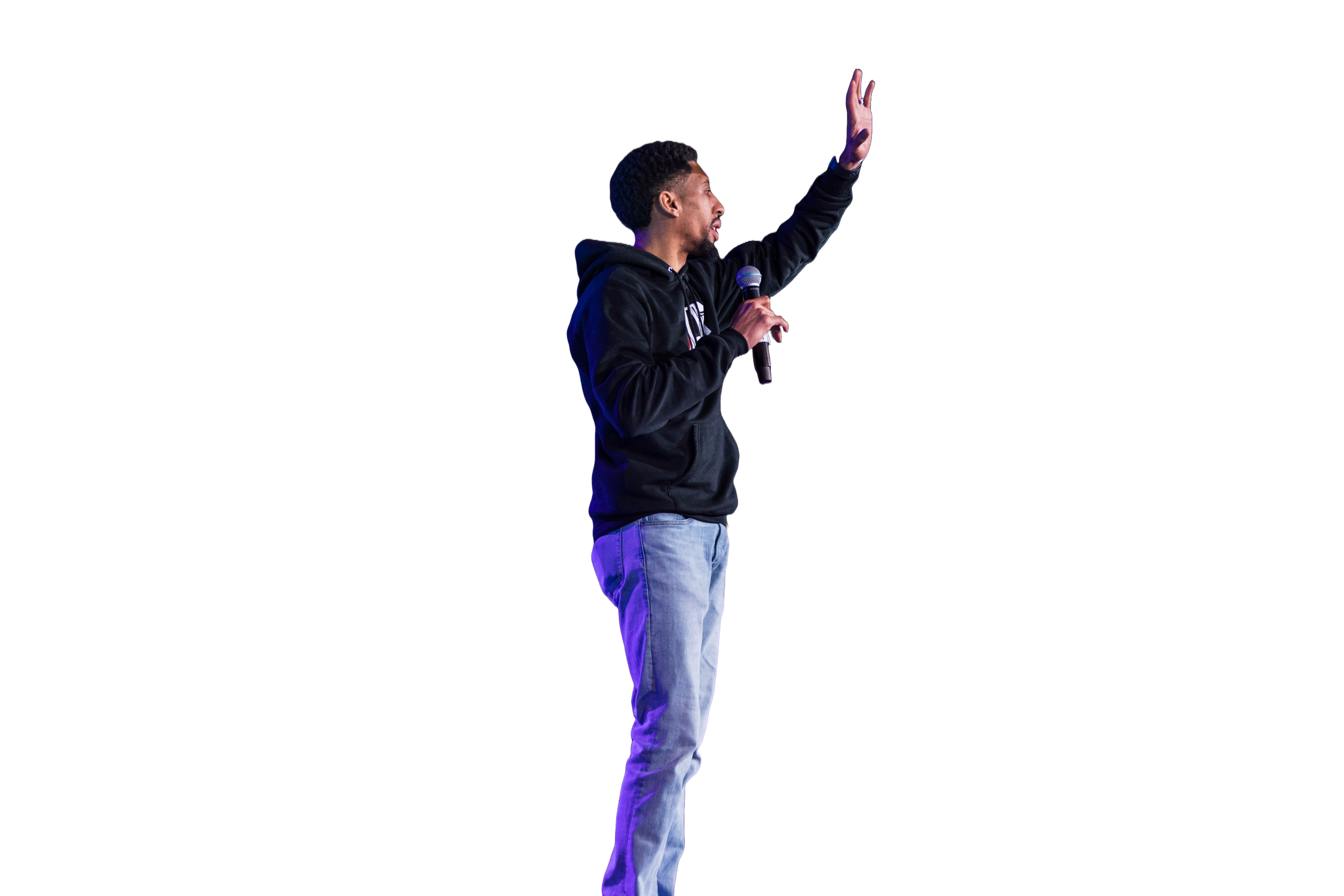 A young man wearing a black hoodie and jeans is giving a presentation on stage, holding a microphone, with a large blue bar graph projected behind him.
