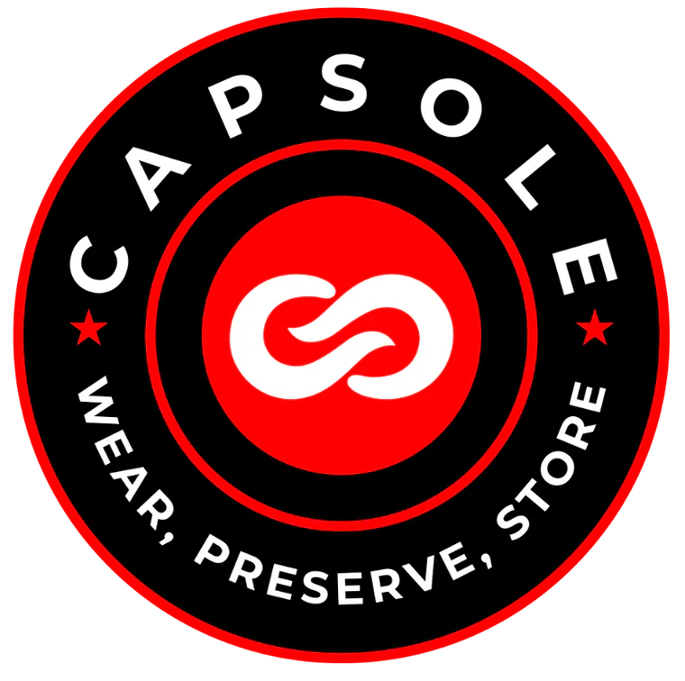 Circular logo for Capsule Wear, Reserve Store, featuring a black background with red and white details, a stylized design at the center, and text in white reading "CAPSULE WEAR, RESERVE, STORE" around the circle.