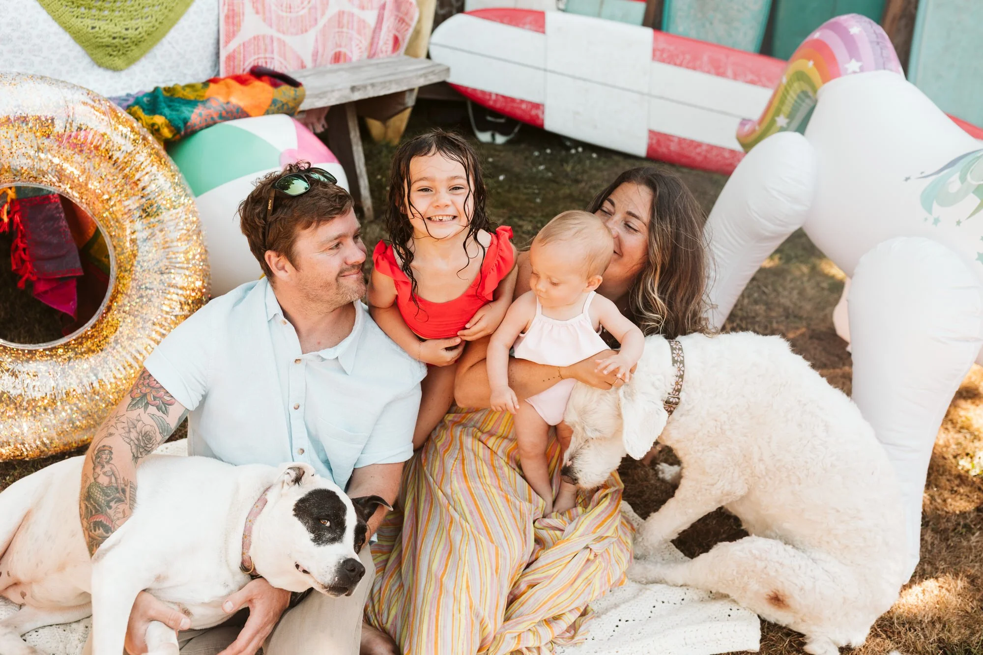 Fun summer family session with floaties and sprinklers and bright colors