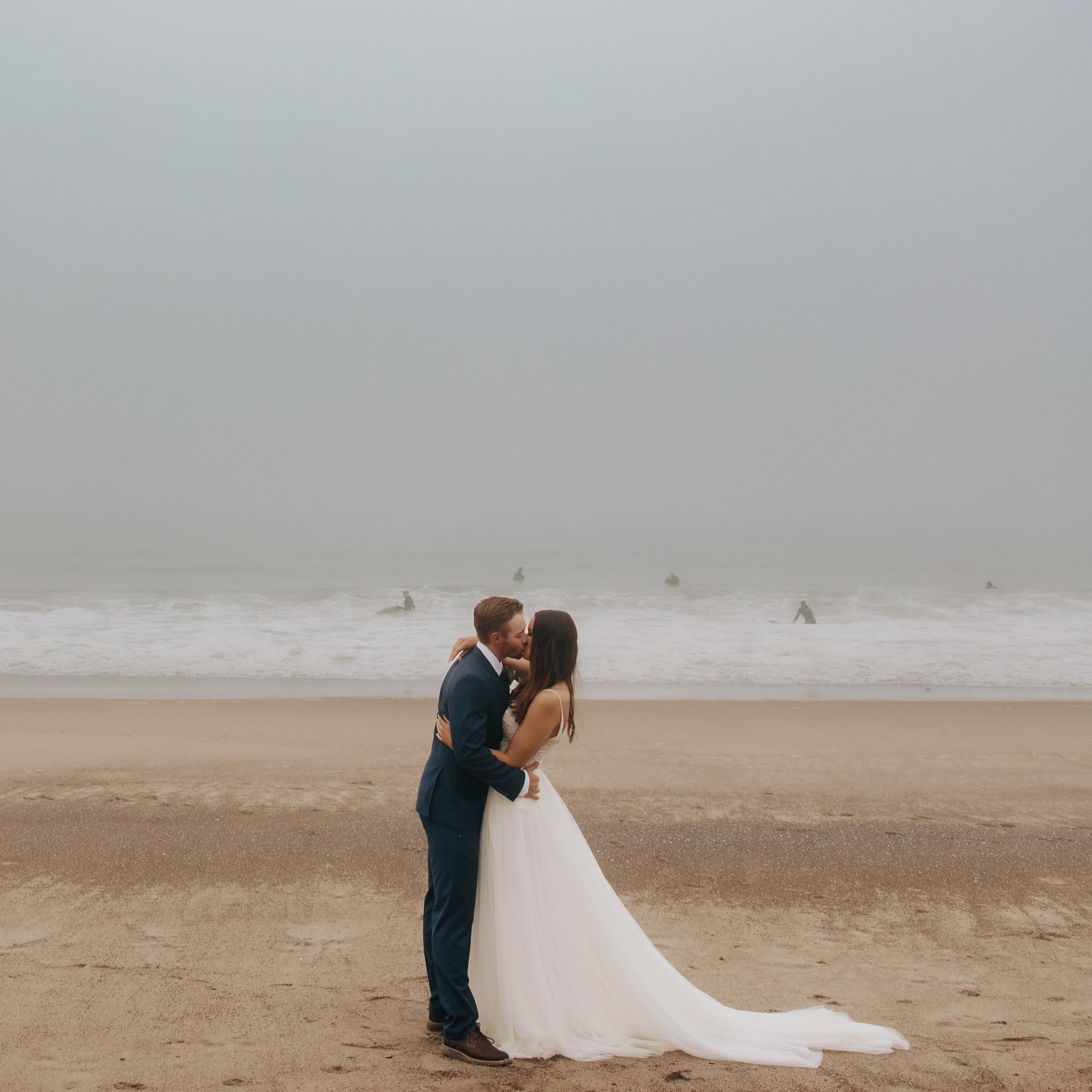 ***FRIDAY FAVORITE*** Kelsey &amp; Tayt ended up with a moody misty overcast day, and I loved every minute of it. Usually, I remove background visitors, but when there&rsquo;s a whole squad of surfers behind you, it&rsquo;s one of my favorite things 