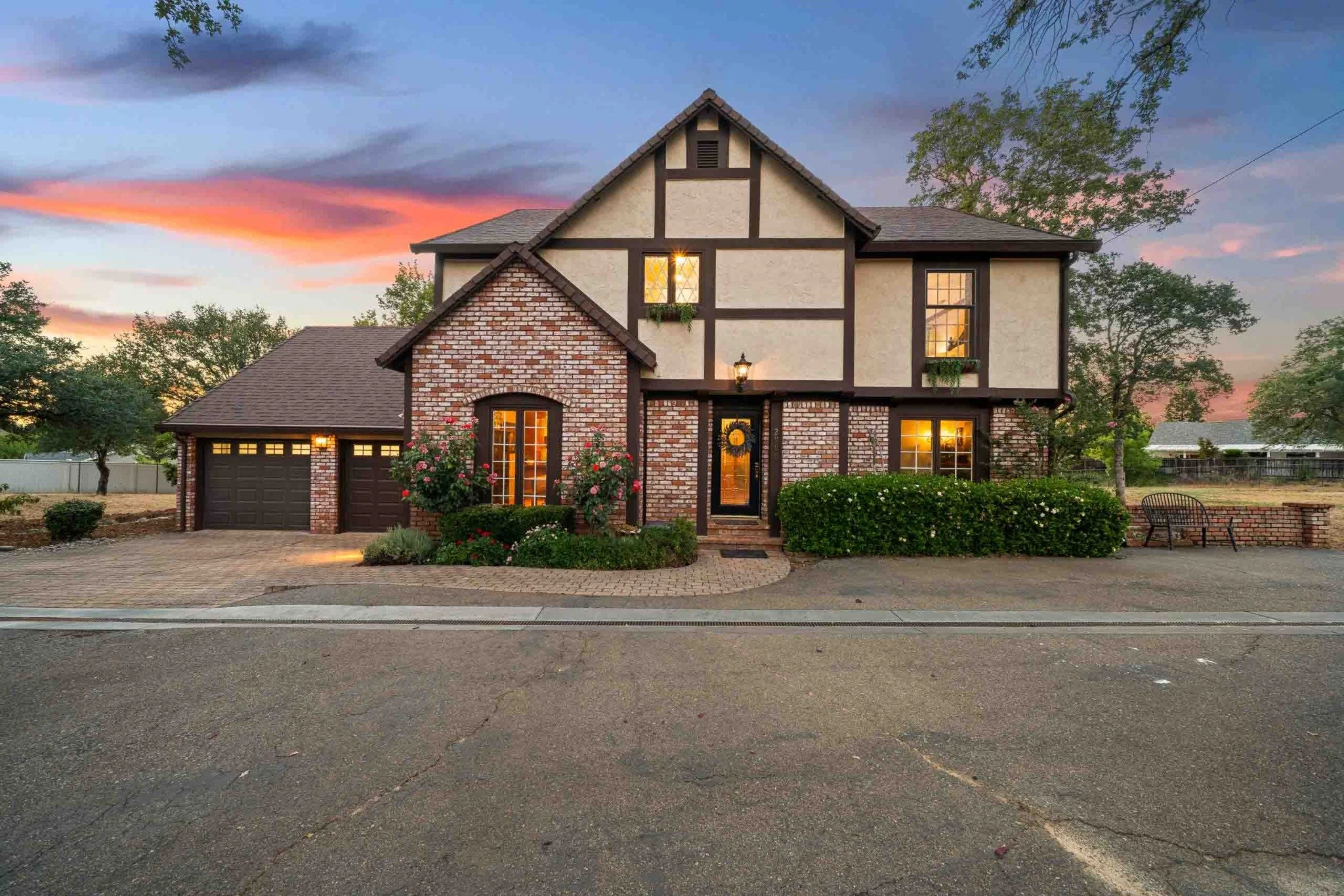 Tudor-style home exterior illuminated at twilight in Redding, California.