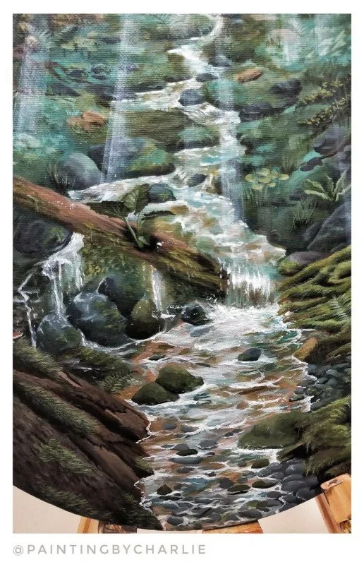 Close up - The sunlight pours in, illuminating the clear water of the forest stream, cascading down the miniscule topography of the forest floor.