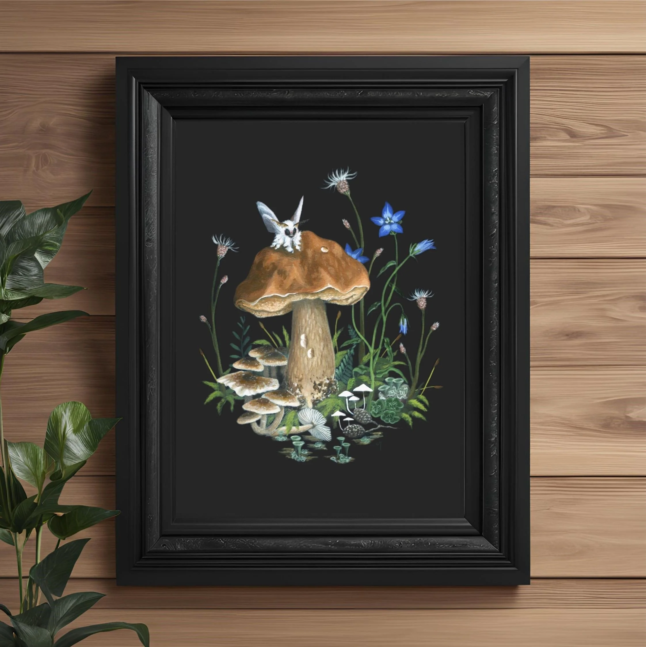 Painting of white Poodle Moth on brown Boletus mushroom, surrounded by bluebell flowers, moss, fungi &lichen, on a black background in black frame, by Charlie Maxwell (PaintingbyCharlie).