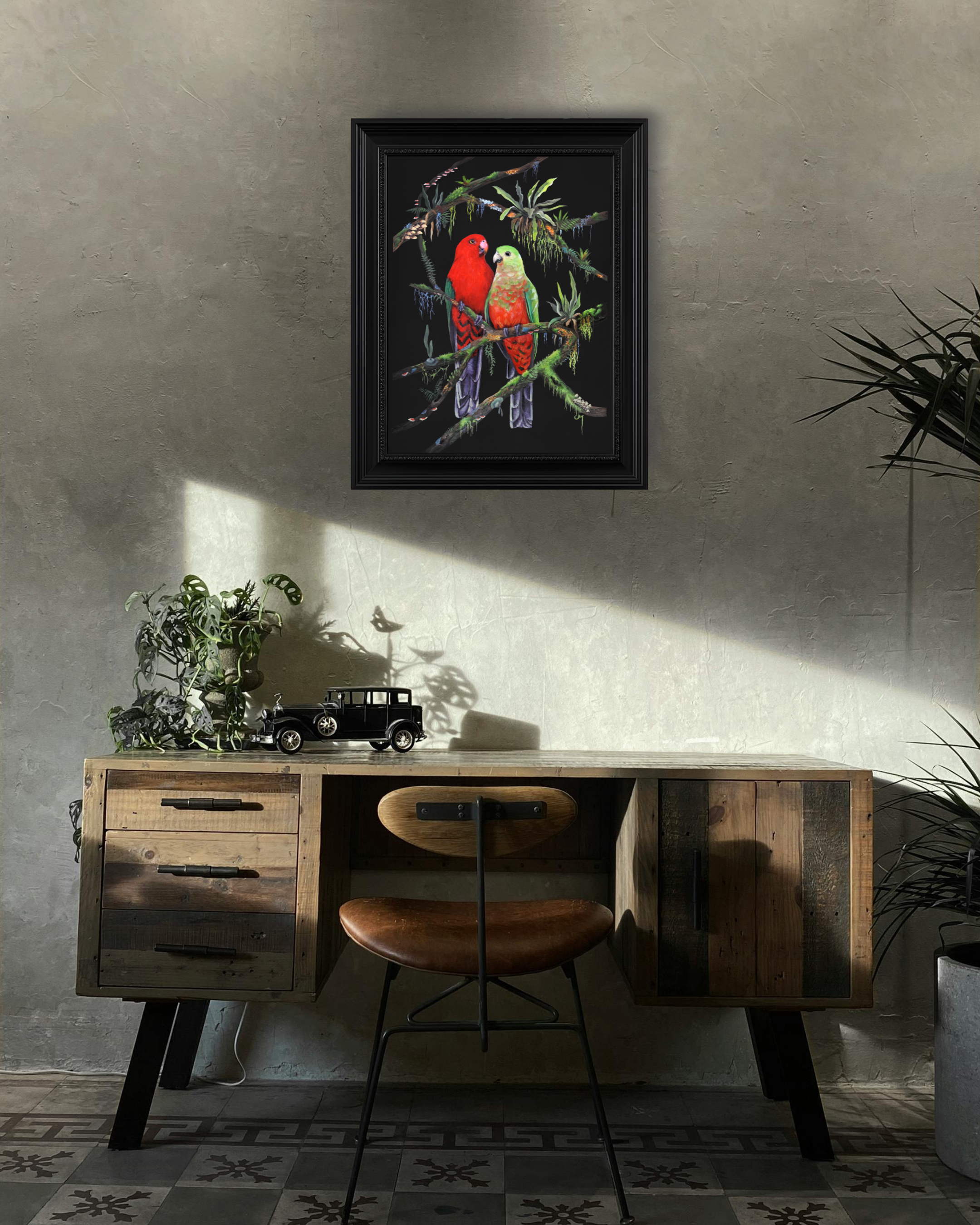 Framed wildlife print two Australian King Parrot birds perched in rainforest canopy with elkhorn ferns, moss, mushrooms & lichen on a black background staged in home office