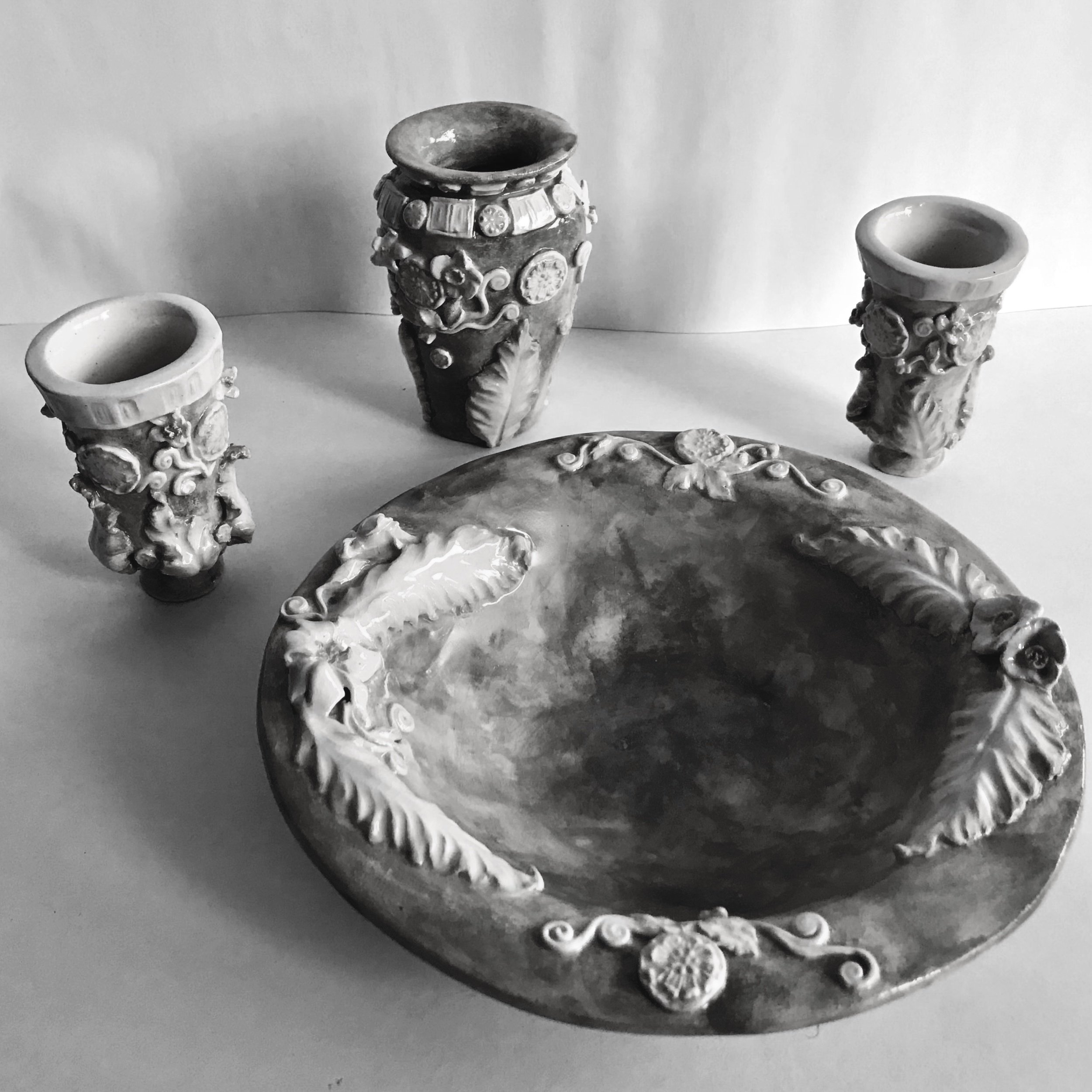 A special commission collection of three Centuripe ware flower vases and a matching bowl. Hand built in Cornish stoneware clay and painted with various tones of olive green and touches of ochre.
