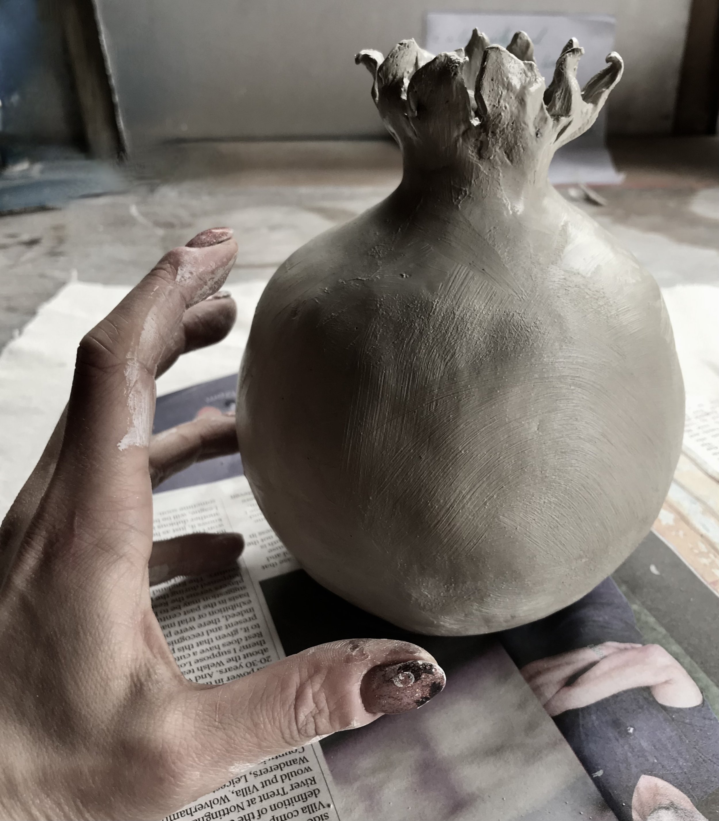 Temptation: greenware pomegranate hand formed from Cornish stoneware clay.