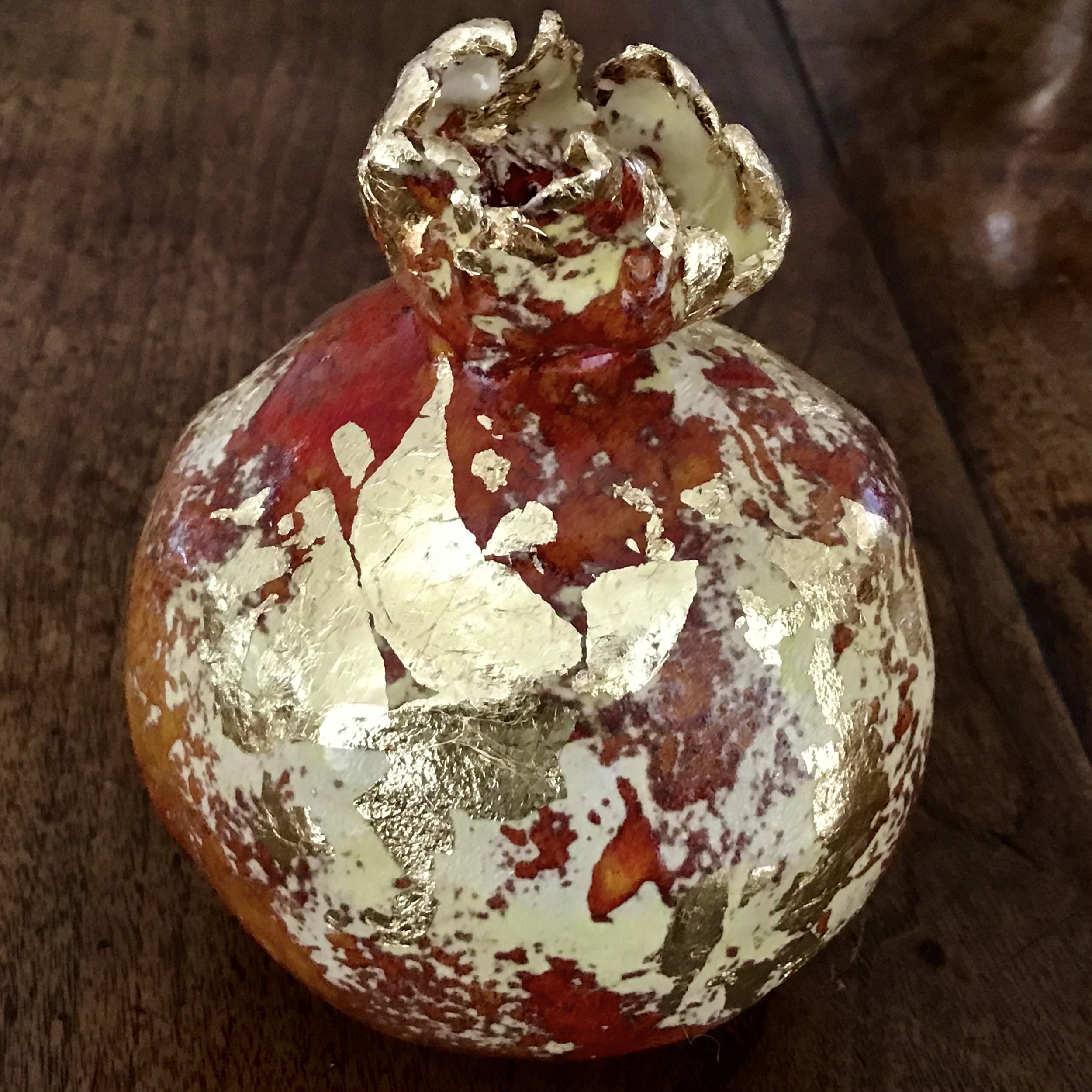 Gilt and Pleasure: a glazed and gilded pomegranate.