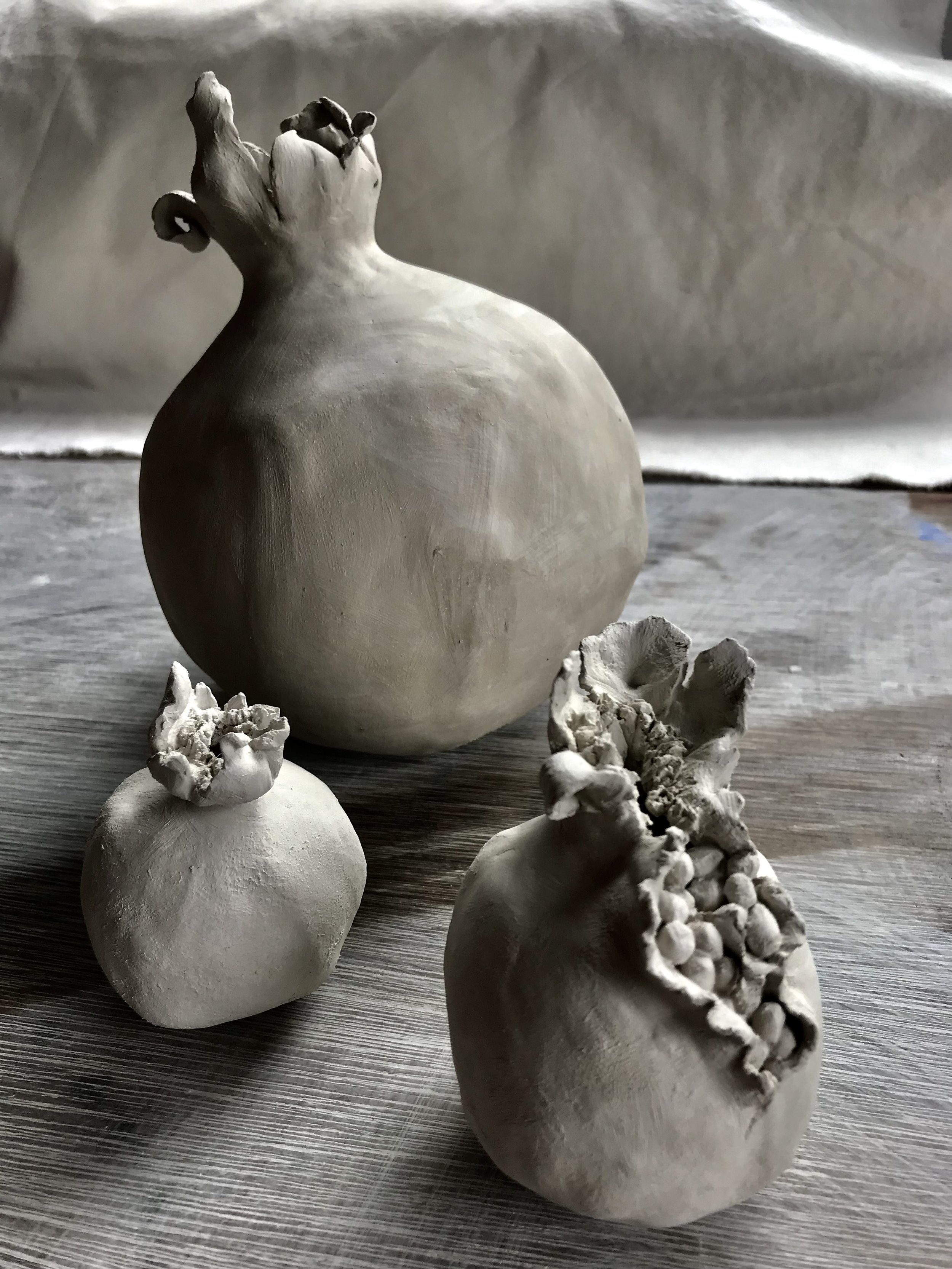 Raw Form: greenware pomegranates hand sculpted from Cornish stoneware clay.