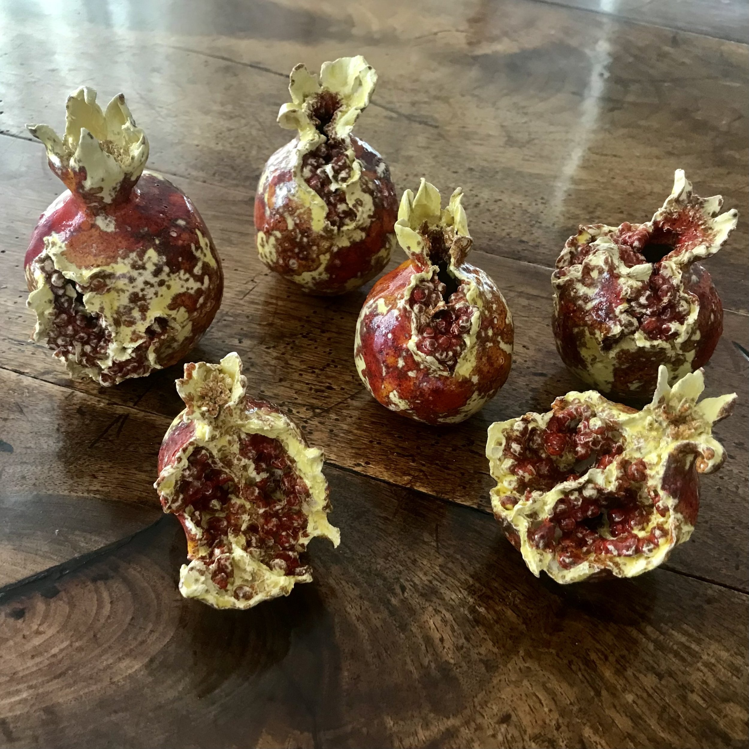 Rupture and Rapture: A cluster of ruptured ceramic pomegranates.