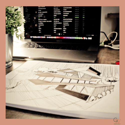 A workspace with a laptop displaying music playlists, a potted plant, and architectural drawings or plans on a wooden desk.