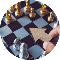 Two women with dark hair and glasses walking in opposite directions on a city sidewalk, with modern building in the background.