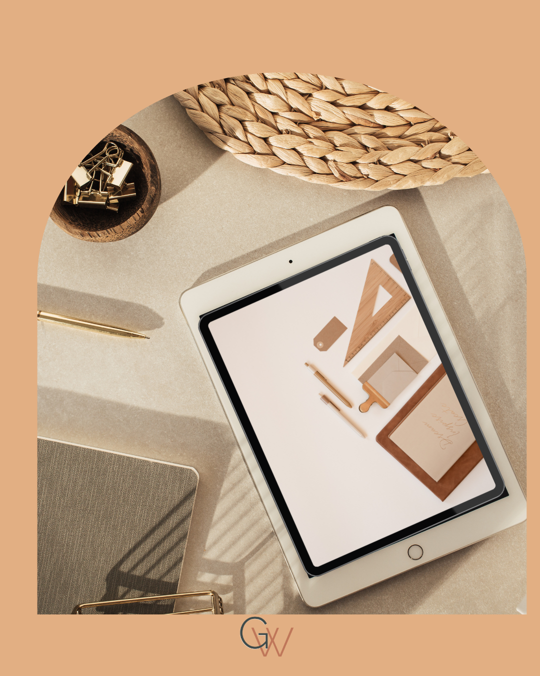 Flat lay of a desk with an iPad displaying design sketches, a gold pen, a gray notebook, a wooden container with gold clips, and a woven basket, all on a beige surface.